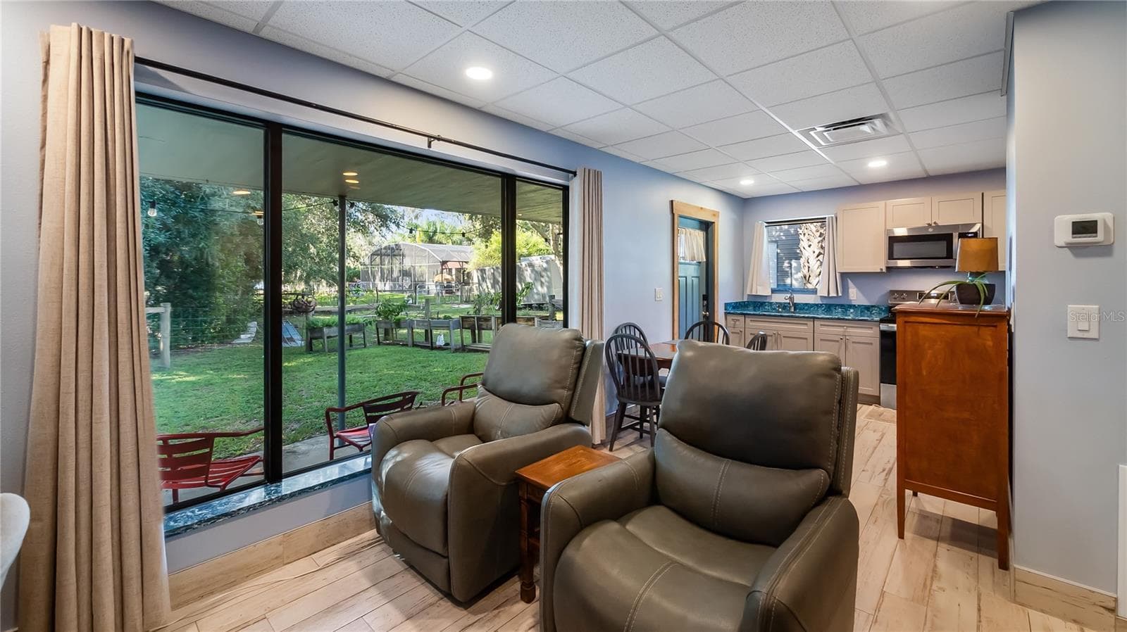 Detached garage and apartment. 2 car parking plus storage. Driveway off Lakeshore drive, little fenced in back yard. Full kitchen, laundry closet. remodeled. Pre wired for generator plug access so it can be run on a generator. - 1730 NITA PL, CLERMONT