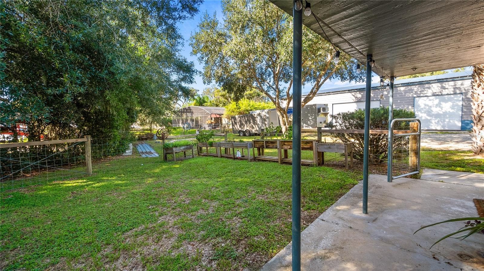 Detached garage and apartment. 2 car parking plus storage. Driveway off Lakeshore drive, little fenced in back yard. Full kitchen, laundry closet. remodeled. Pre wired for generator plug access so it can be run on a generator. - 1730 NITA PL, CLERMONT