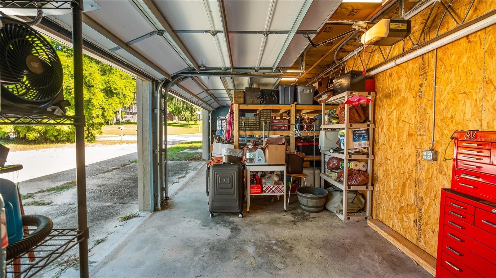 Detached garage and apartment. 2 car parking plus storage. Driveway off Lakeshore drive, little fenced in back yard. Full kitchen, laundry closet. remodeled. Pre wired for generator plug access so it can be run on a generator. - 1730 NITA PL, CLERMONT