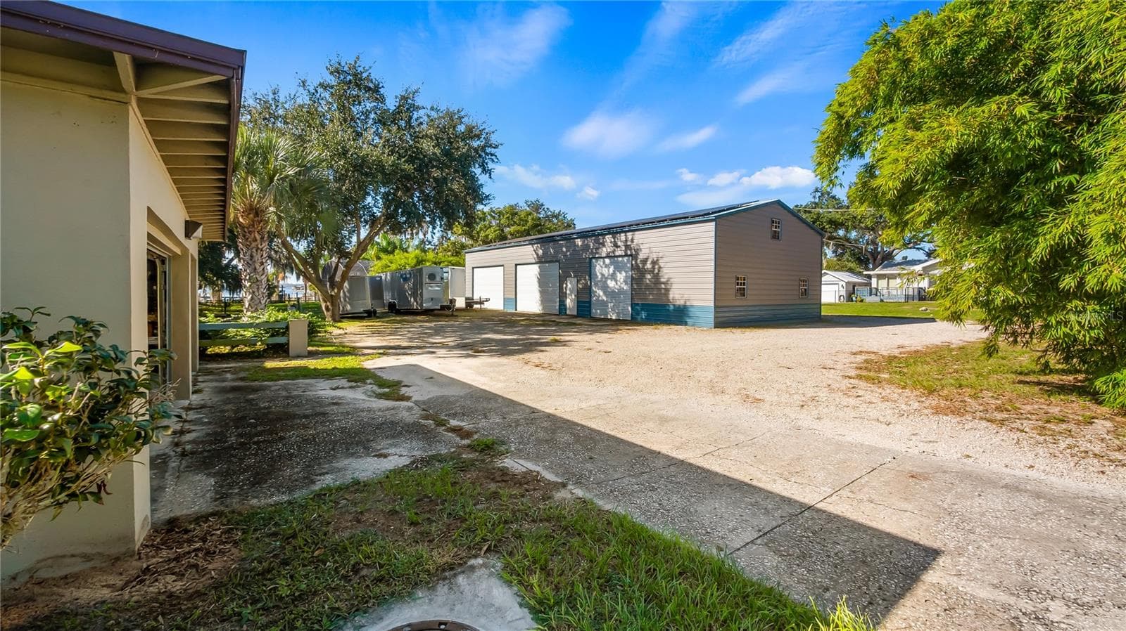 Driveway off Lakeshore Dr to detached garage apartment and backside of metal building. - 1730 NITA PL, CLERMONT