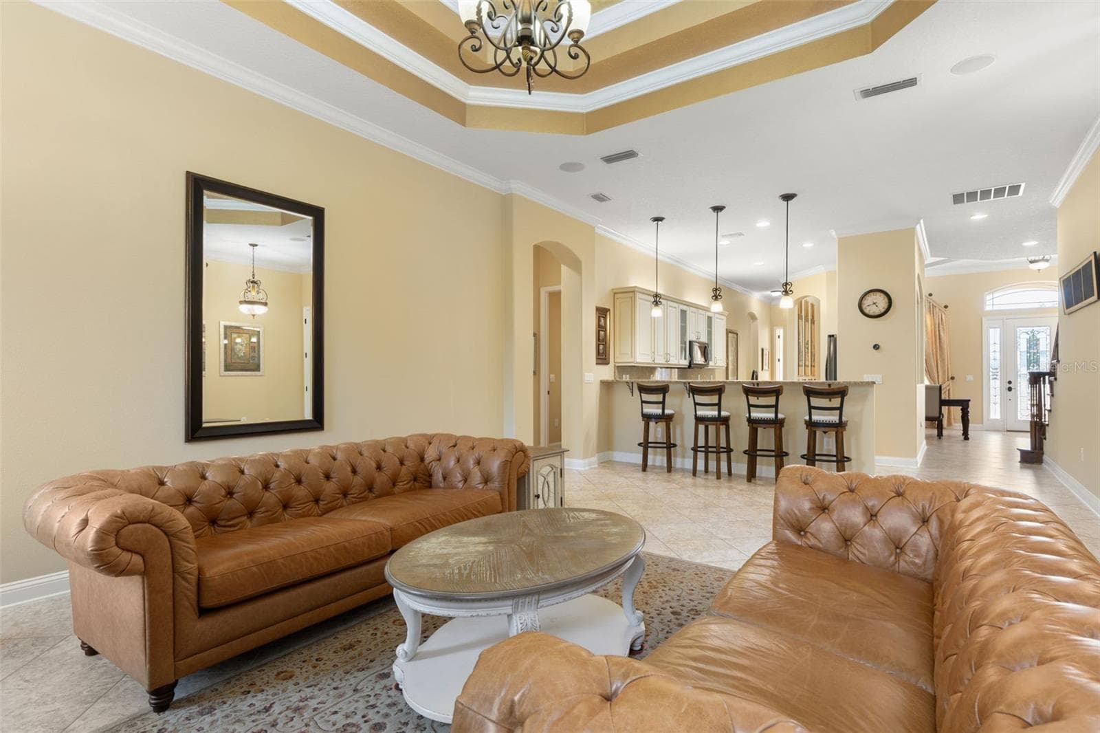 An open, welcoming layout offers a view toward the home's front entrance, showcasing the thoughtful connection between living spaces. - 25 EMERALD LAKE CT, PALM COAST