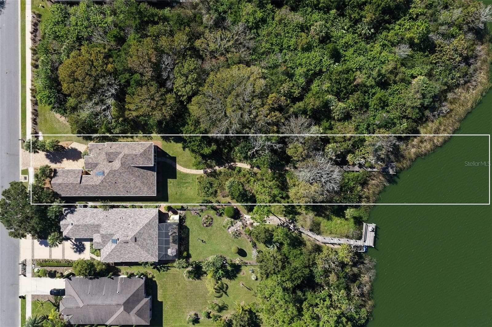 Overhead aerial showcasing the property's spacious 0.57-acre setting, natural conservation landscape, and private walkway leading to Emerald Lake. - 25 EMERALD LAKE CT, PALM COAST