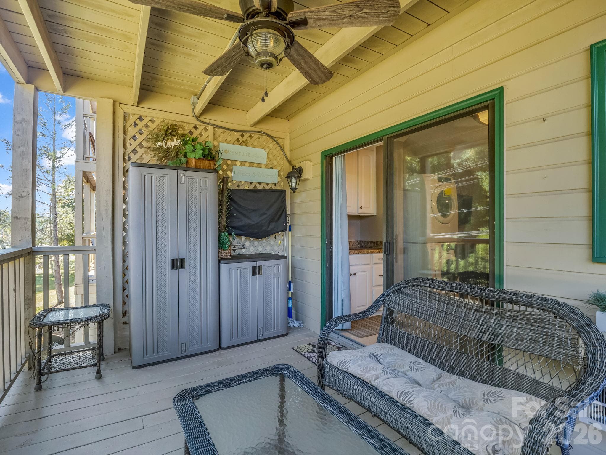 Covered back porch, complete with an installed TV—the perfect spot to relax, catch the game, or watch a movie. - 160 Whitney Boulevard, Lake Lure