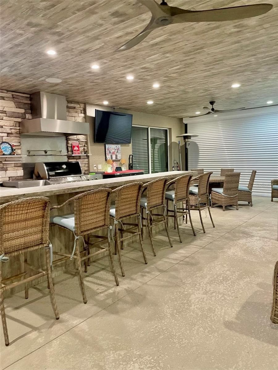 Hurricane shutters protecting the outdoor kitchen. - 2851 VILLAGE GREEN CT, AVON PARK