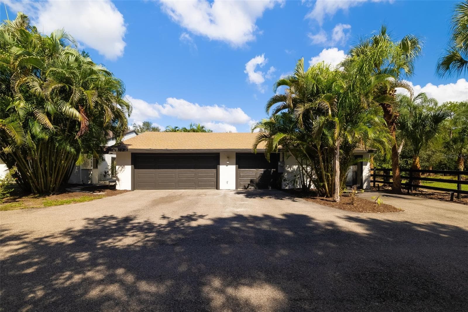 CAR ENTHUSIASTS TAKE NOTE—this substantial extended three-car garage provides exceptional space for vehicles, storage, tools, hobbies and more. - 403 LONGBOW TRL, OSPREY