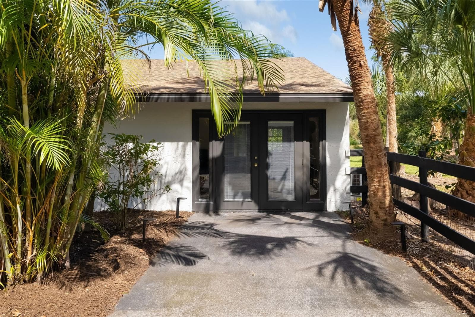 A private exterior entrance enhances the versatility of this additional bedroom, bath and living area—well suited for guests, extended family, an in-law-style retreat, office or multigenerational living. - 403 LONGBOW TRL, OSPREY