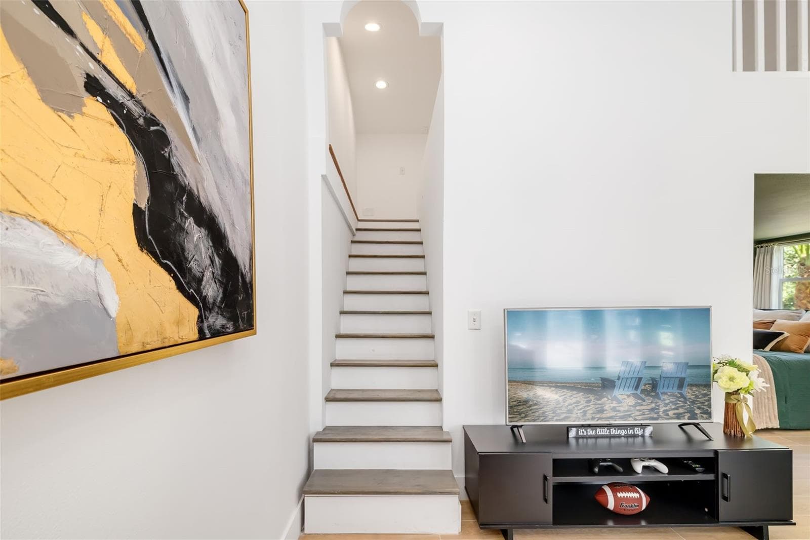Additional living area and staircase leading to the loft/flex space—part of a highly adaptable portion of the home ideal for guests, extended family or multigenerational living. - 403 LONGBOW TRL, OSPREY