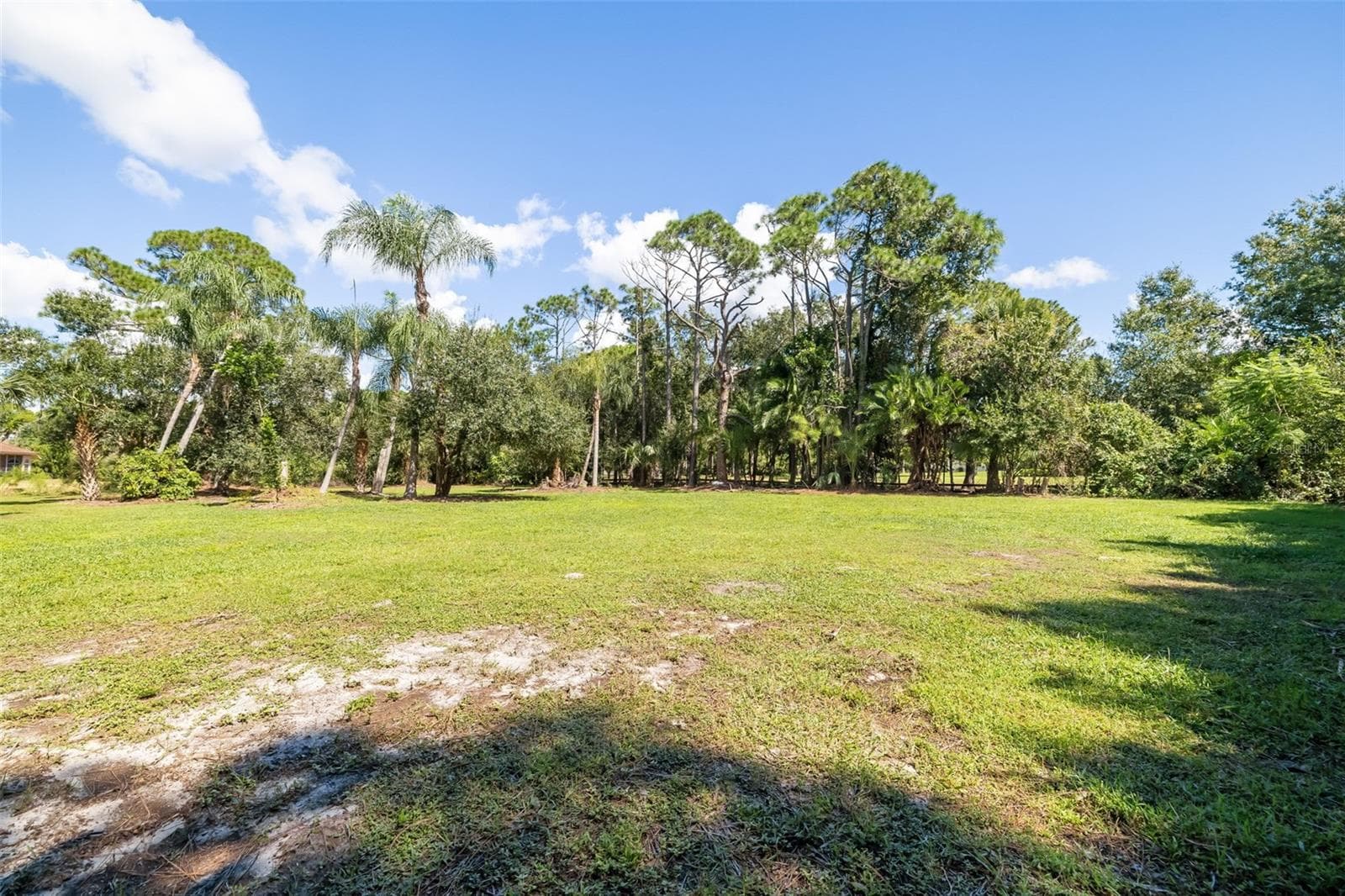 Expansive open acreage offering potential for a future RV/boat garage, collector-car garage, workshop, barn or other accessory structure, subject to applicable approvals. - 403 LONGBOW TRL, OSPREY