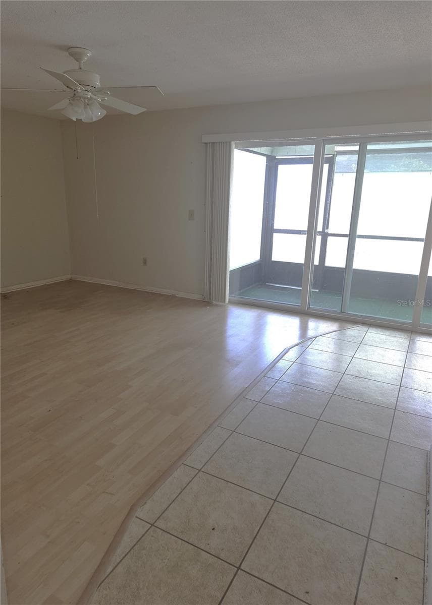 living room with slider to lanai - 1594 COUNCIL DR, SUN CITY CENTER