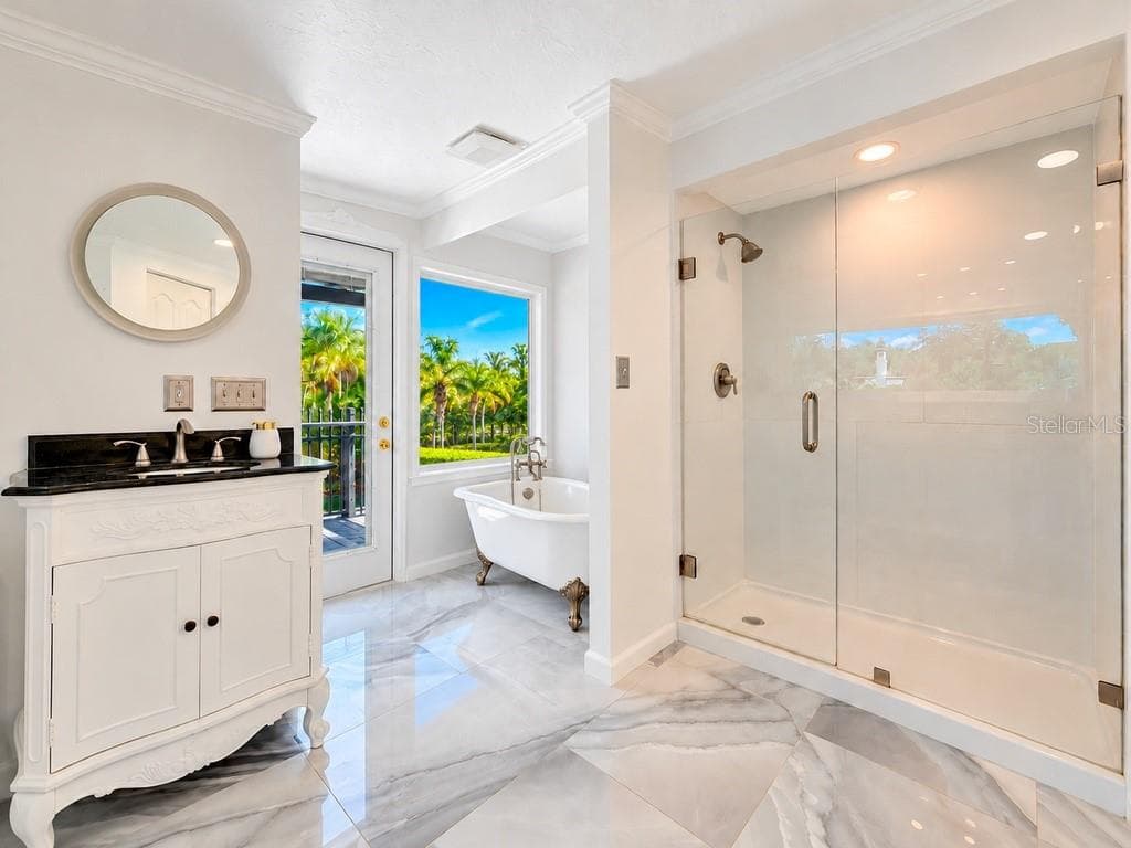 VIRTUALLY RENOVATED – Imagine the possibilities! Conceptual renovation of the upstairs primary bath featuring a freestanding tub, picture window and refreshed finishes. Improvements shown are not currently existing. - 403 LONGBOW TRL, OSPREY