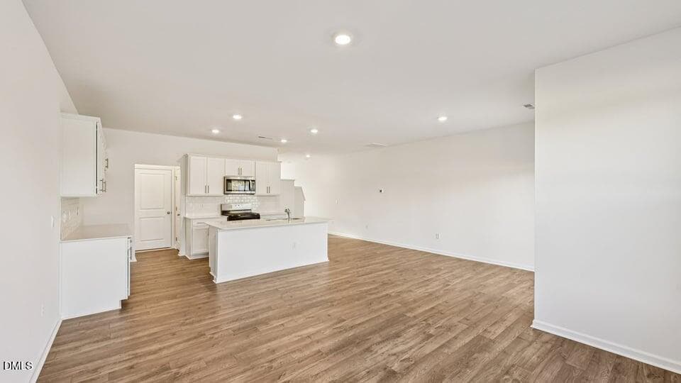 DINING ROOM, LIVING ROOM, AND KITCHEN - 7450 Eden Bush Drive, Raleigh, NC 27604