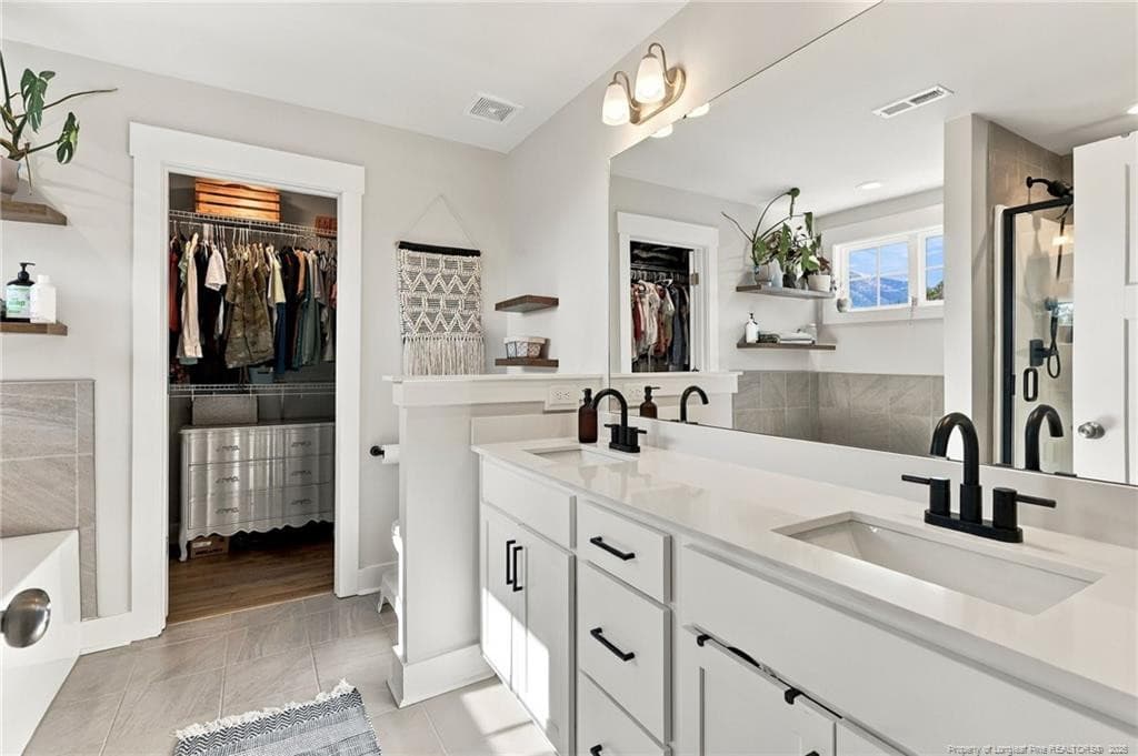 Primary bathroom with double vanities. - 1400 Chason Road, Lumber Bridge, NC 28357