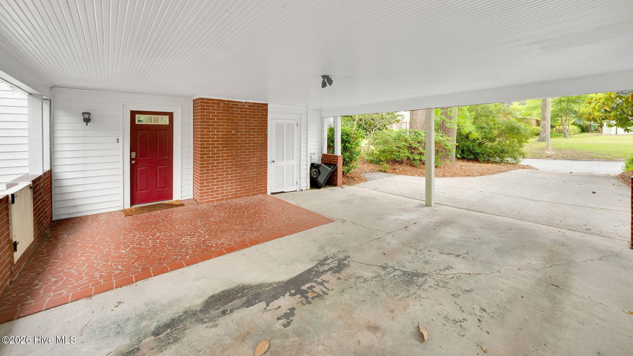 red door enters to huge den with fireplace - 1902 Sherwood Drive, Greenville, NC 27858