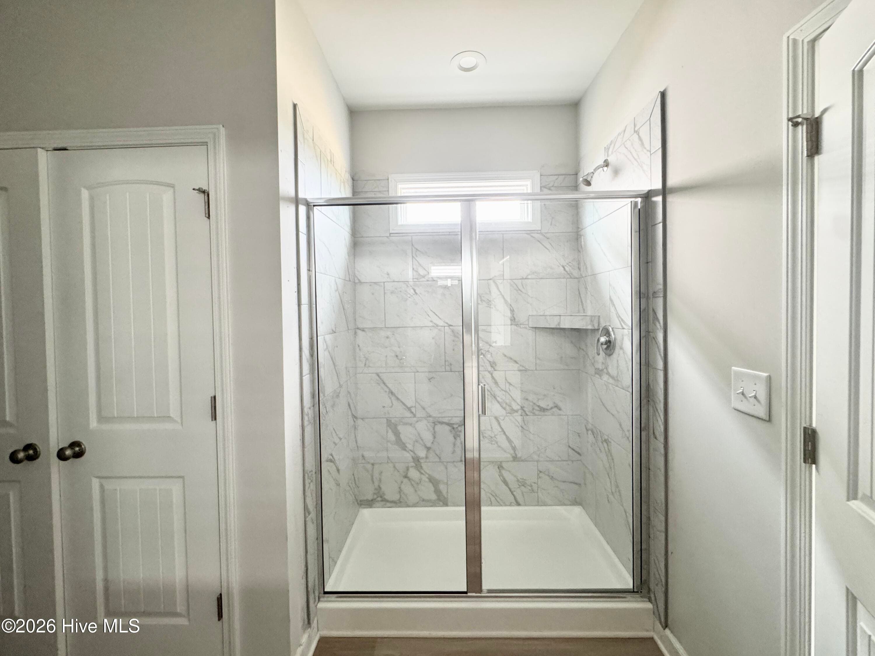 Primary suite features a Private Bathroom with Tile Shower and Large Walk-in Closet - 4208 Workman Loop 94, Leland, NC 28451