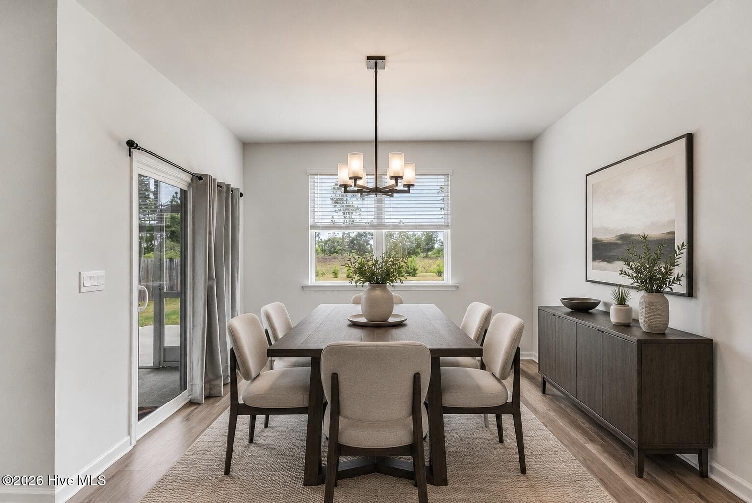 virtually staged dining area with updated lighting fixture - 1038 Burled Oak Ridge Loop SE, Bolivia, NC 28422