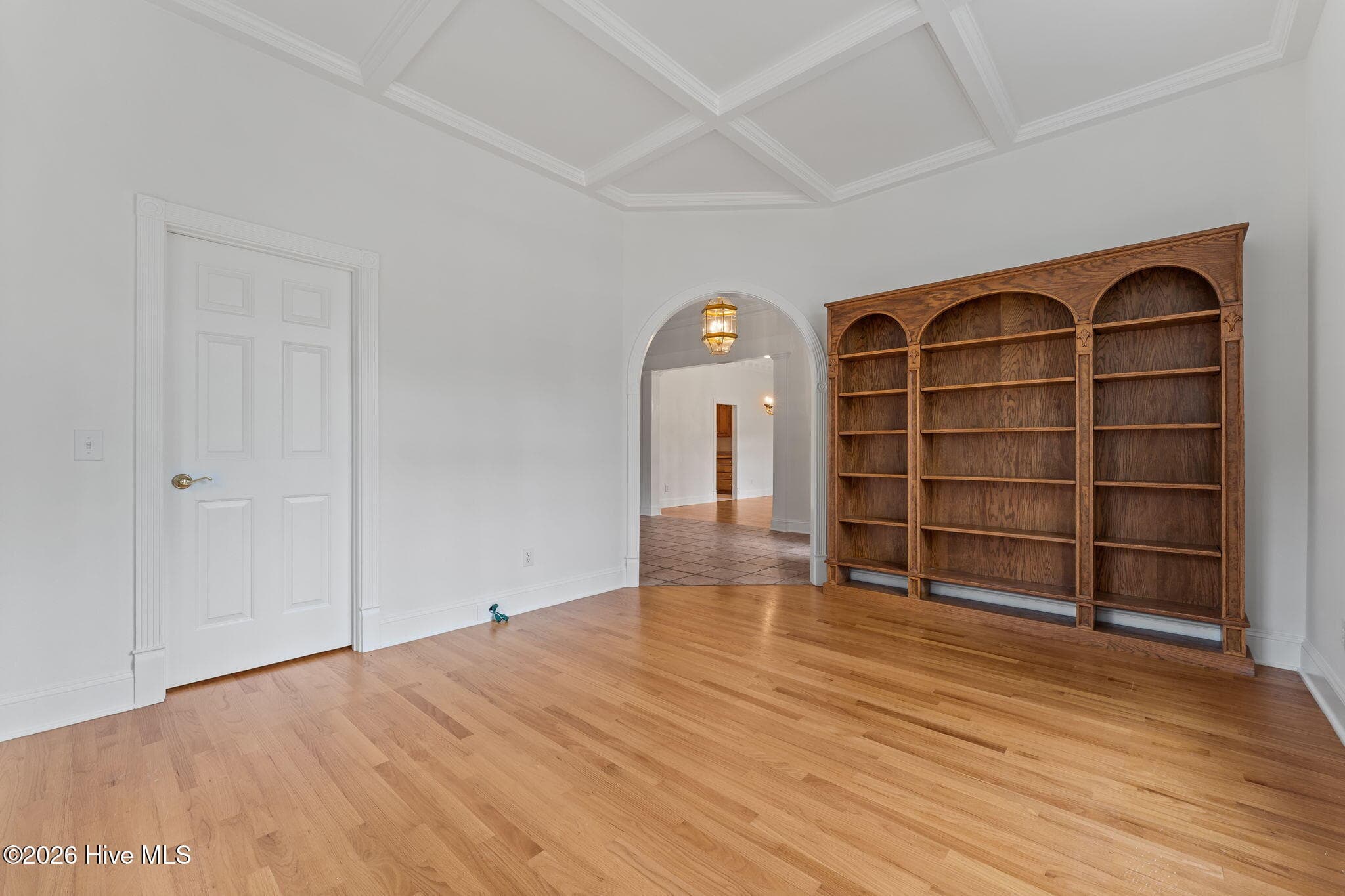 Looking at the den from the far right corner with views of the Bookcases and a door to a closet. - 22 Lochmere Drive, Pinehurst, NC 28374