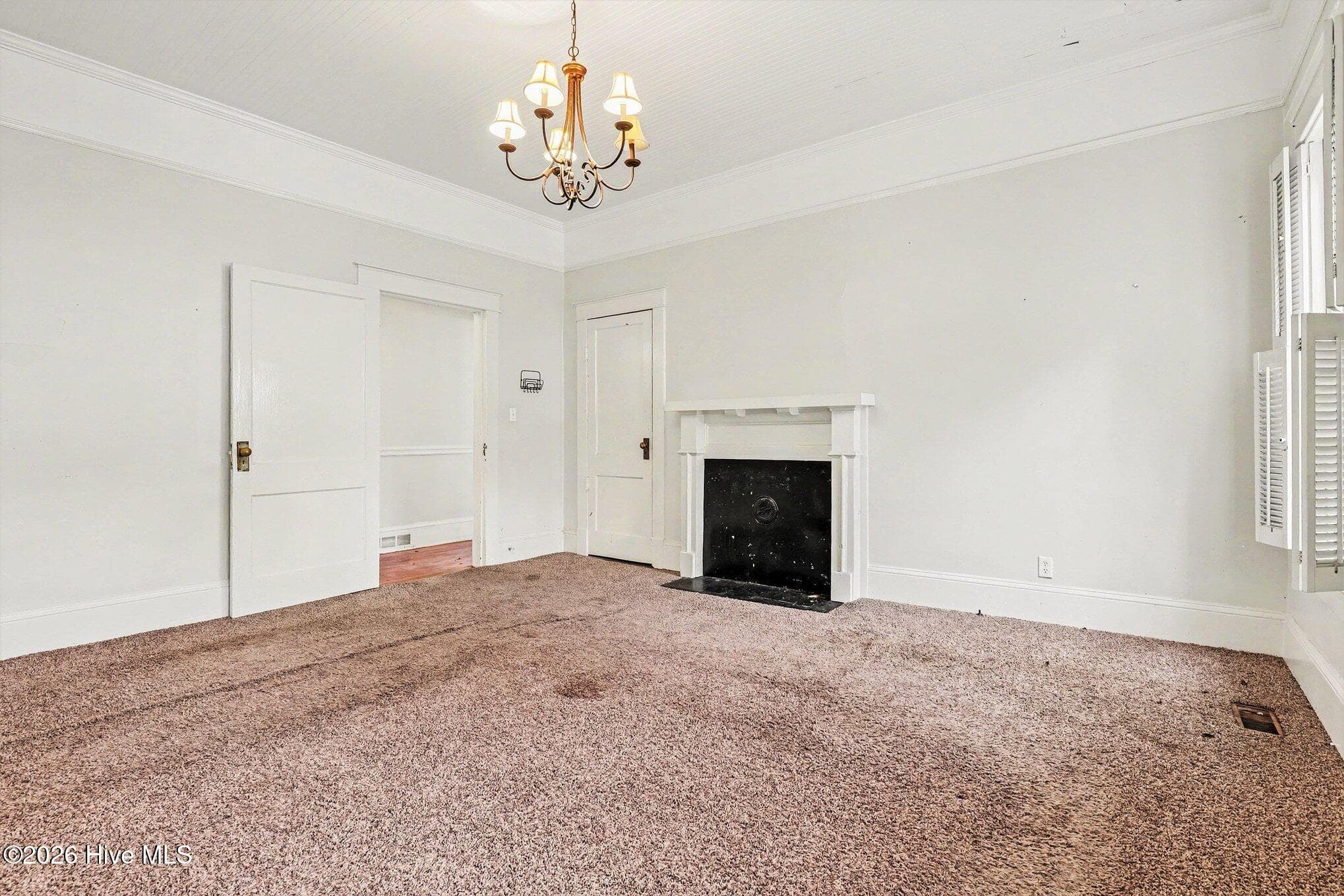 Primary Bedroom with fireplace. Condition of FP is unknown. - 202 N Green Street, Selma, NC 27576