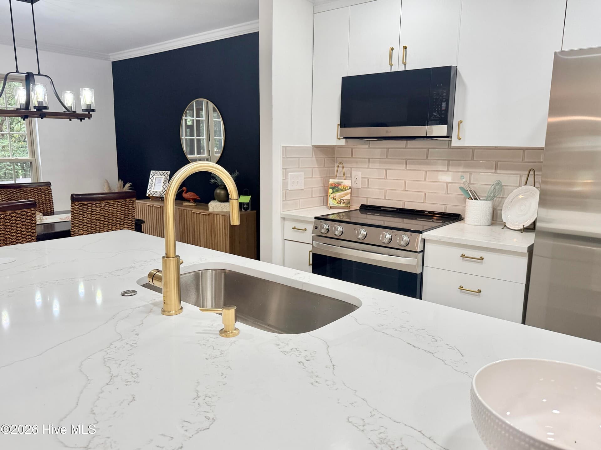 Garbage disposal button on quartz and hidden electrical outlets make for high end upgrades! - 1001 Hunting Ridge Road, Wilmington, NC 28412