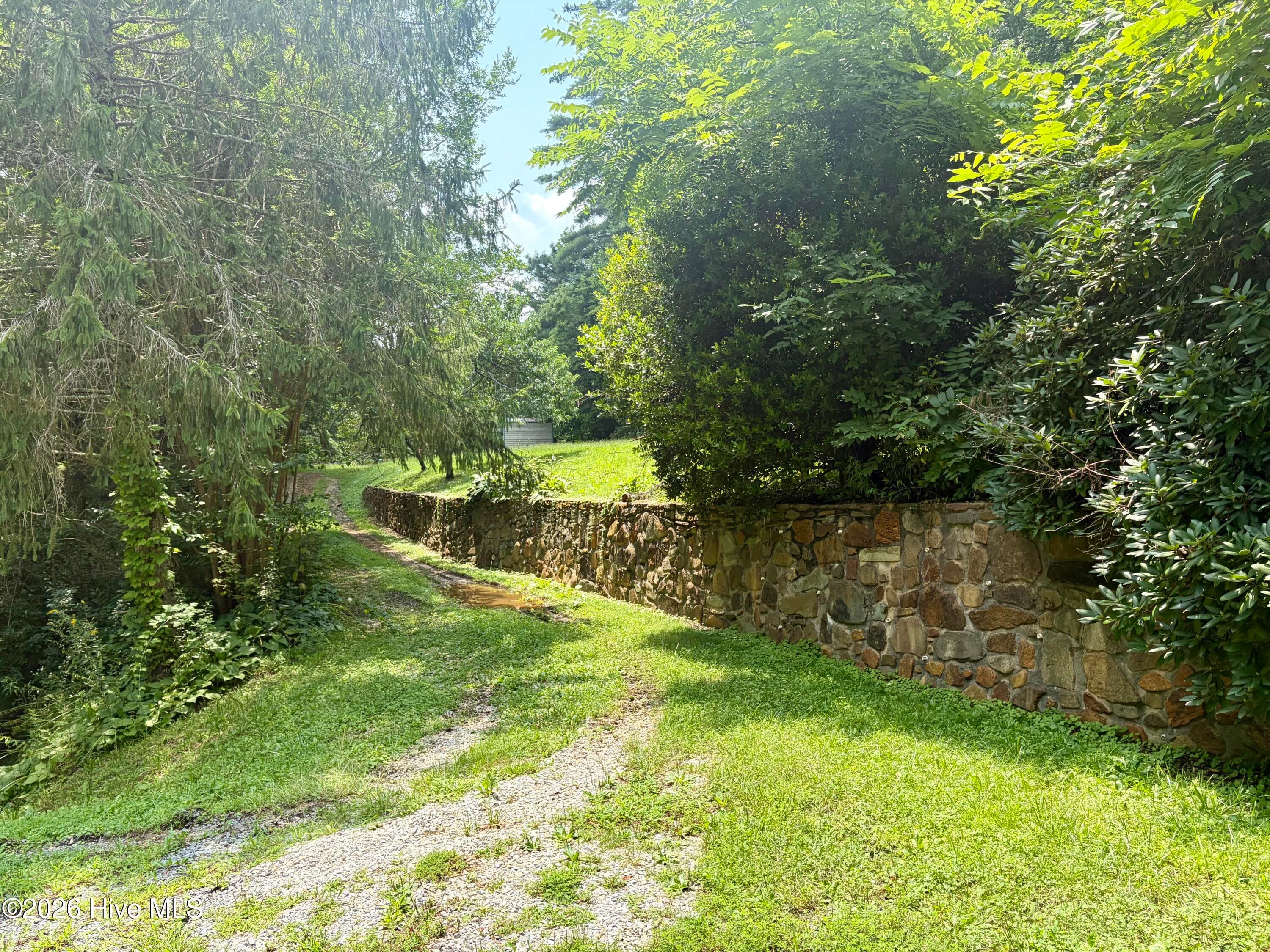 Beautiful rockwork leading sideyard & storage buildings - 913 Franks Creek Road, Robbinsville, NC 28771
