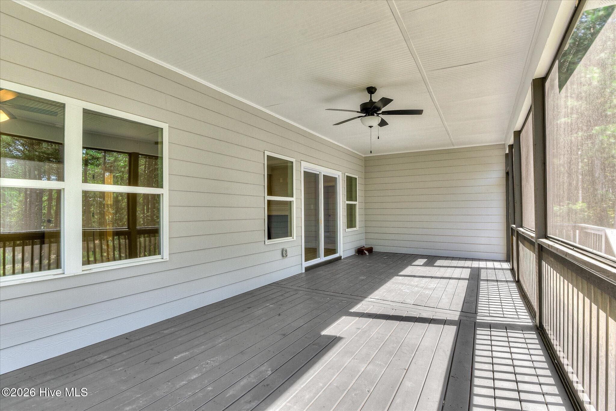 Screened porch stretches across the back of the home. - 1198 Sunset Cove, Tignall, GA 30668