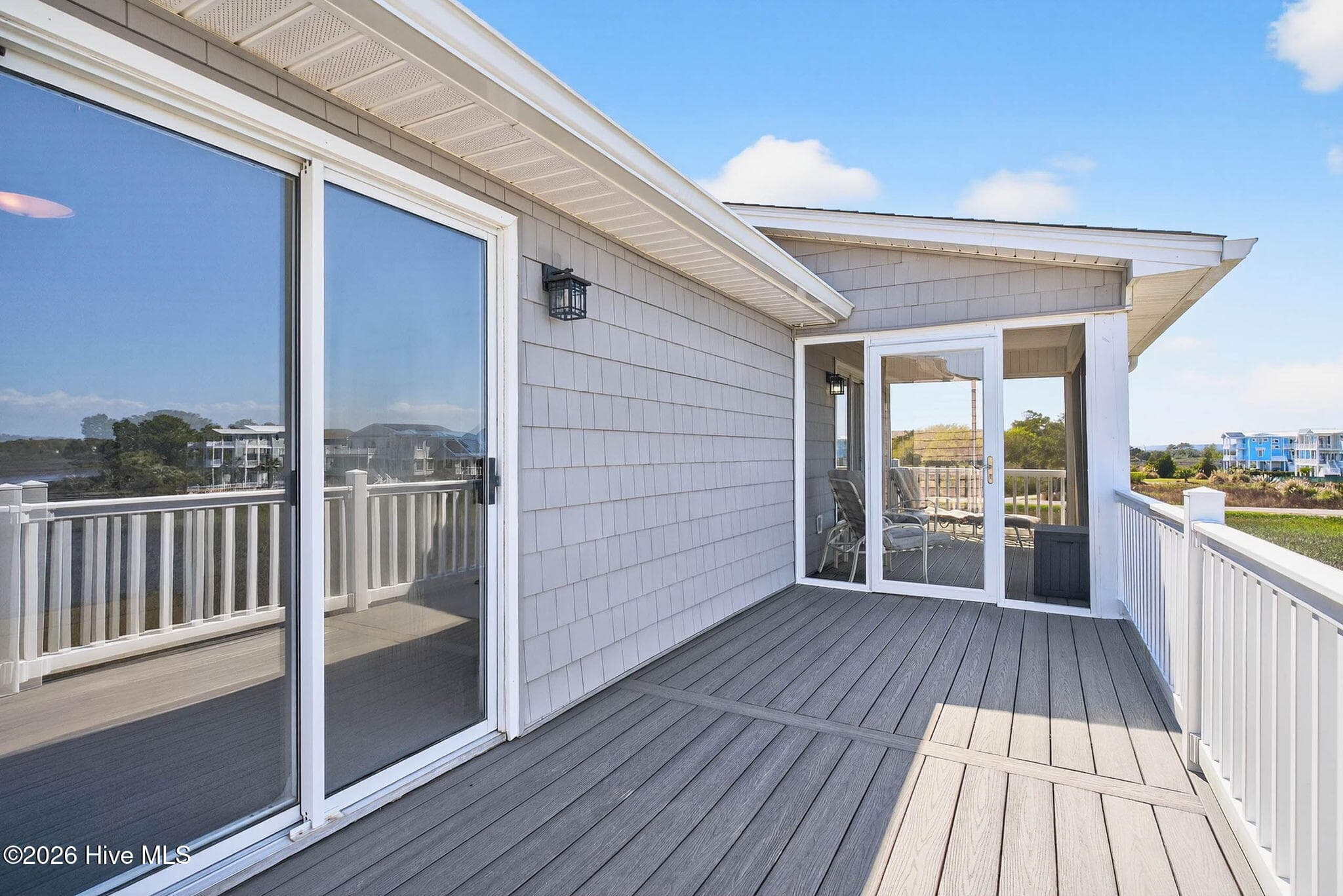 Private deck access via sliding glass doors with beautiful marsh and ICW views. - 1206 N Shore Drive W, Sunset Beach, NC 28468, Sunset Beach