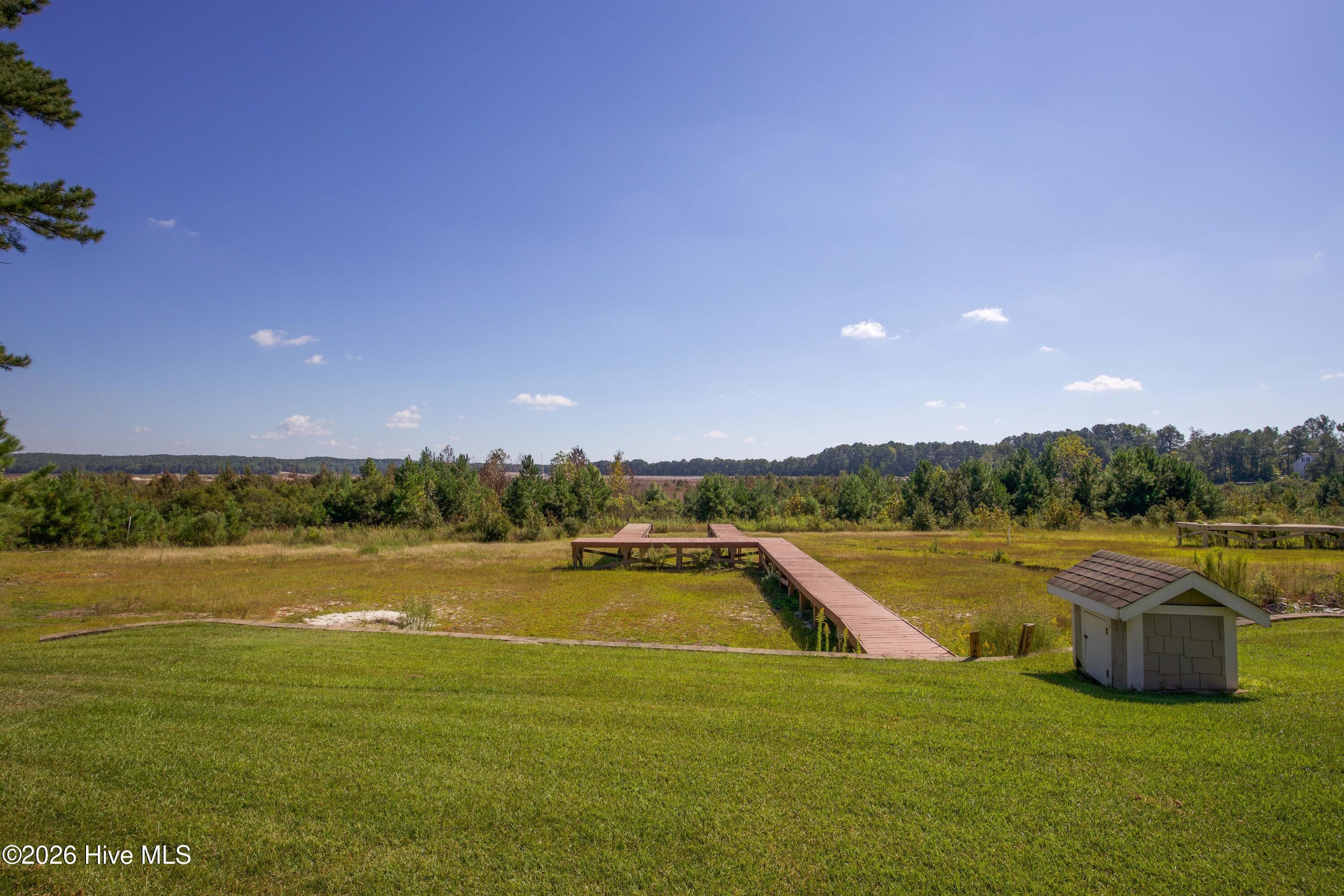 Rear lawn and existing dock with the dry lakebed beyond. - 899 Seagull Drive, Vass, NC 28394, Vass