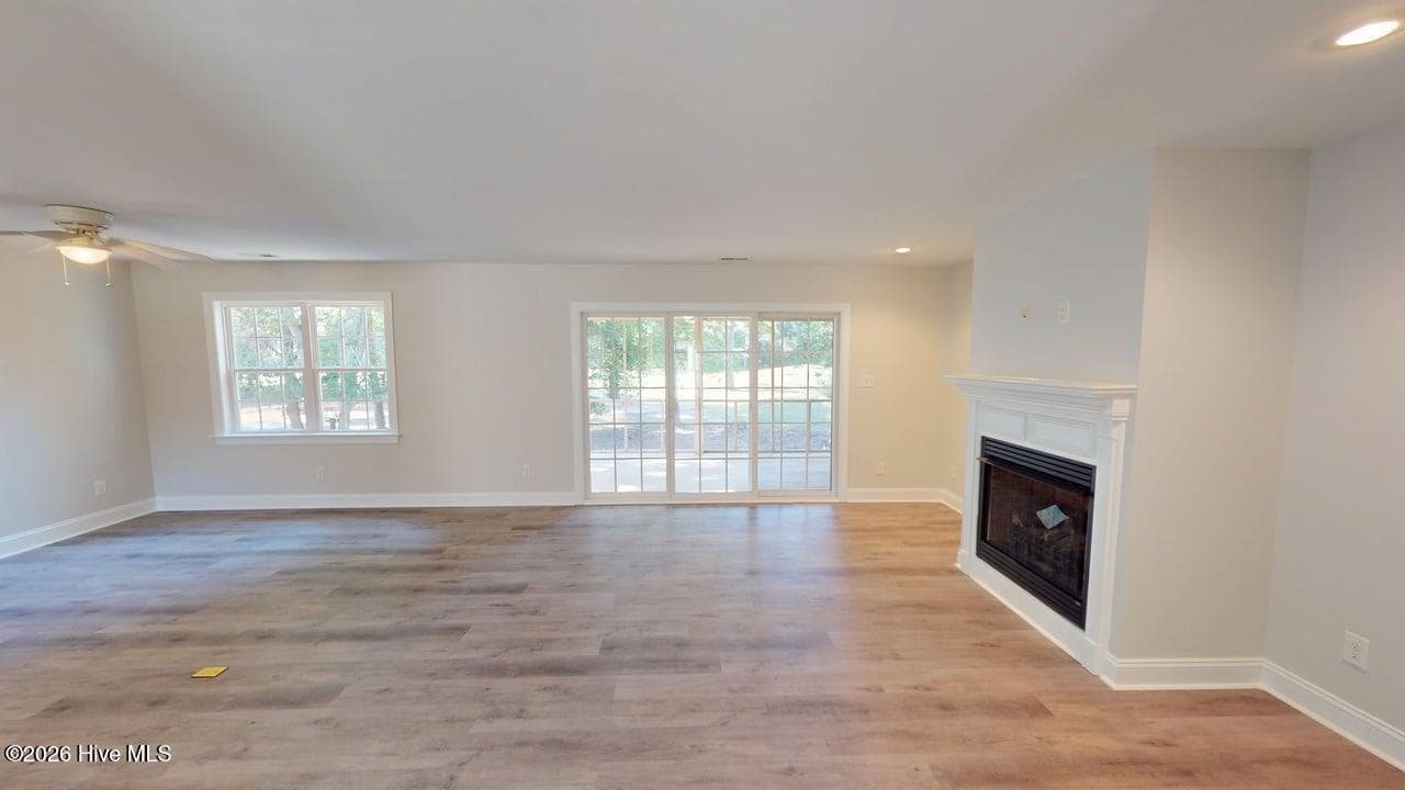 Gas log fireplace and sliding glass doors to the back screened in porch. - 1114 Barkentine Drive, New Bern, NC 28560