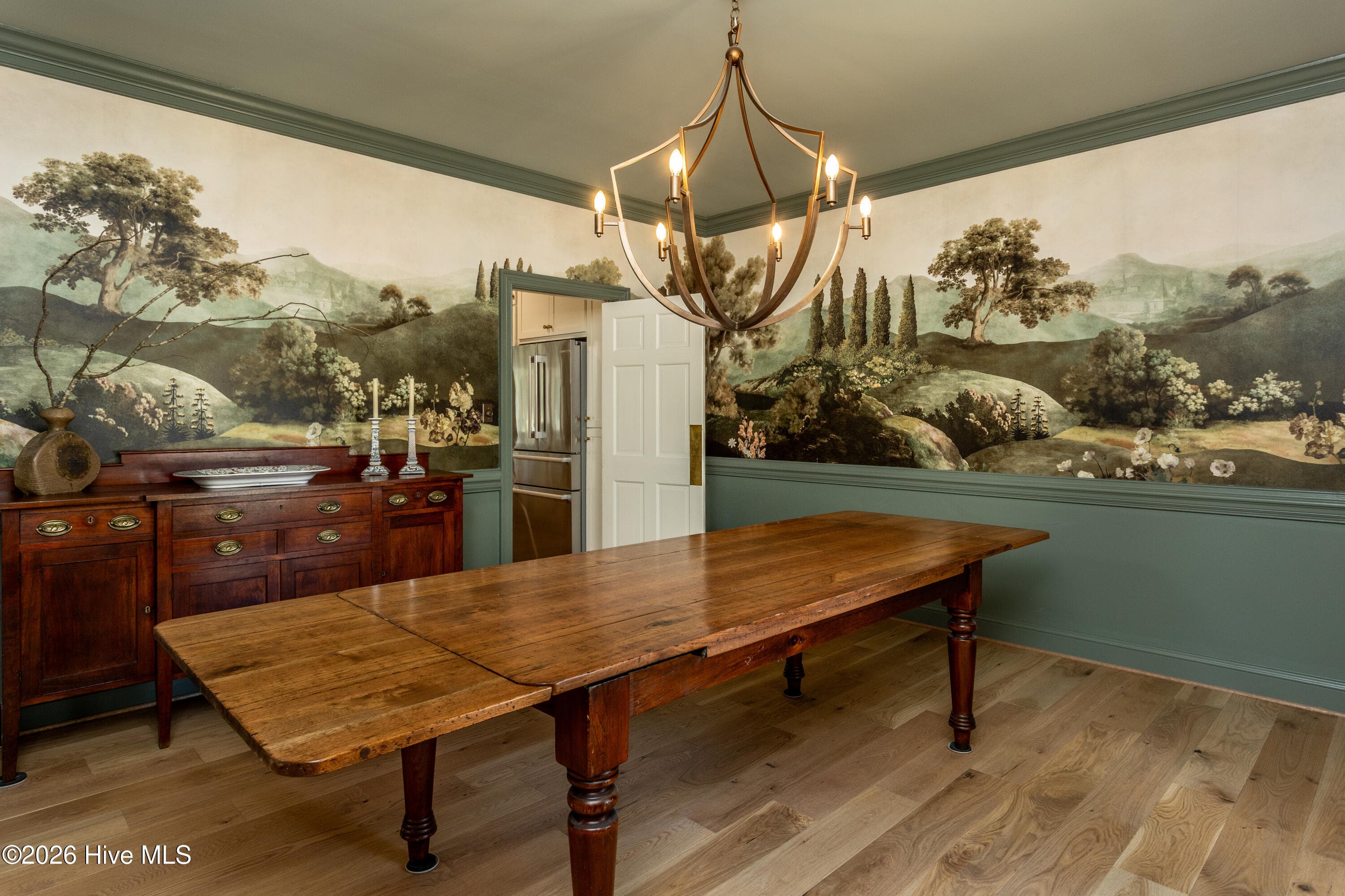 Old World Charm in this large dining room with beautiful wallpaper mural and fabulous chandelier. - 5050 Country Club Drive N, Wilson, NC 27896
