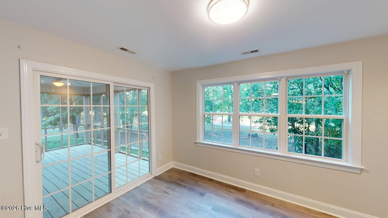 Looking out over the backyard and the putting green, with sliding glass doors to the Screened Porch! - 1114 Barkentine Drive, New Bern, NC 28560