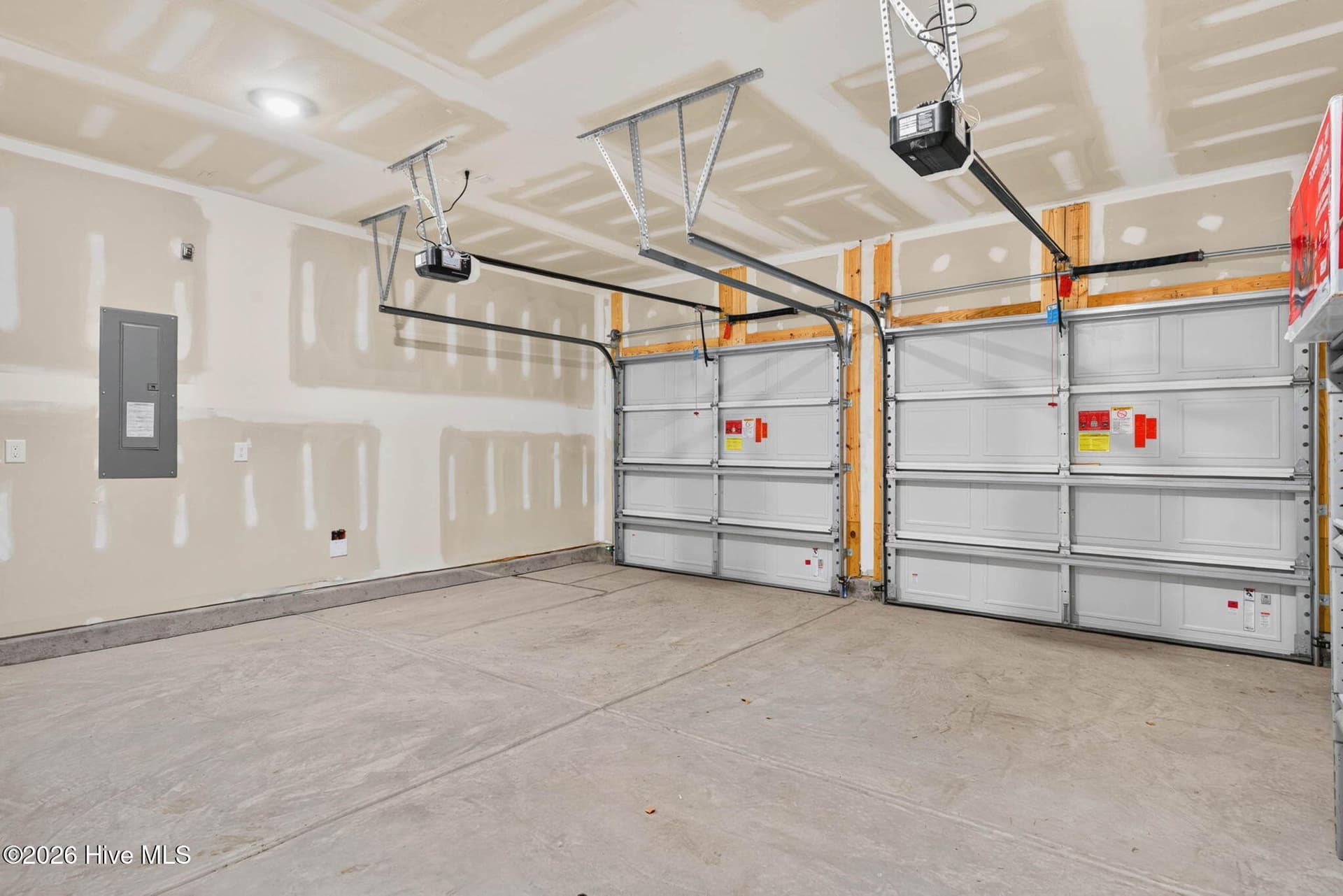 Attached two-car garage offering ample space for vehicles, storage, and beach essentials. - 3447 Sandhill Crane Drive SW, Ocean Isle Beach, NC 28469