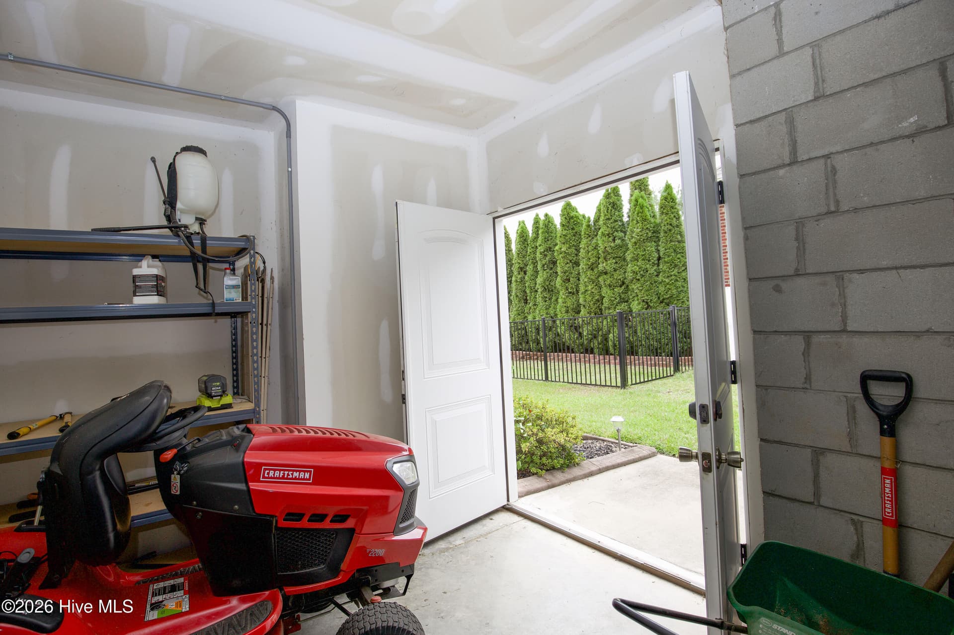 Basement storage room with an exterior door, useful for lawn equipment. - 899 Seagull Drive, Vass, NC 28394