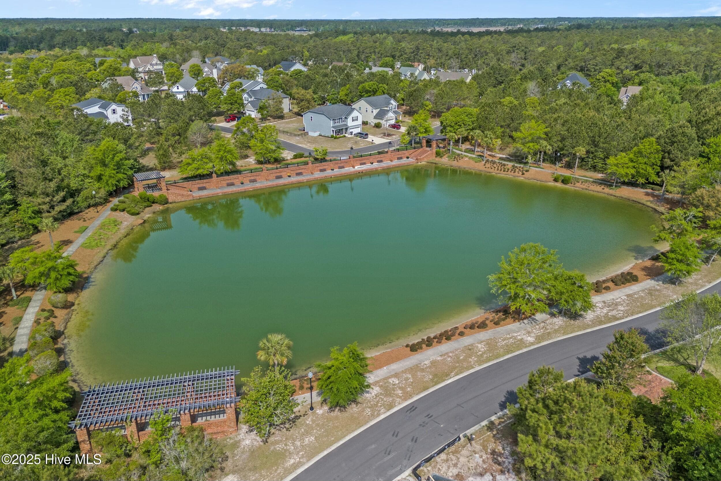 A tranquil pond with a promenade—ideal for both relaxation and recreation. - 3088 130 Brackenbury Street SW, Shallotte, NC 28470, Shallotte