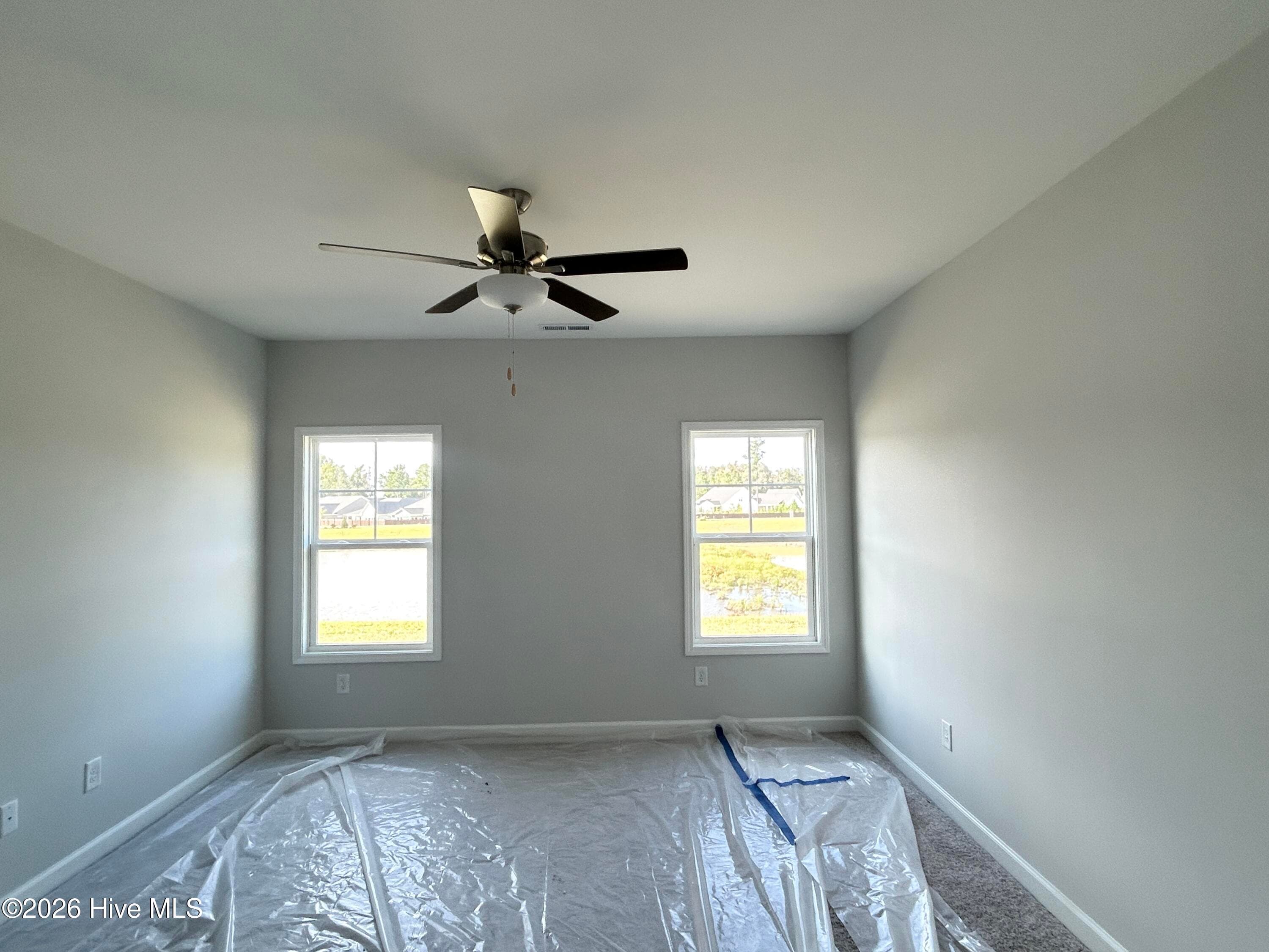 Primary Suite features a Private Bathroom with Tile Shower and Large Walk-in Closet - 9117 Carly Lane 61, Leland, NC 28451