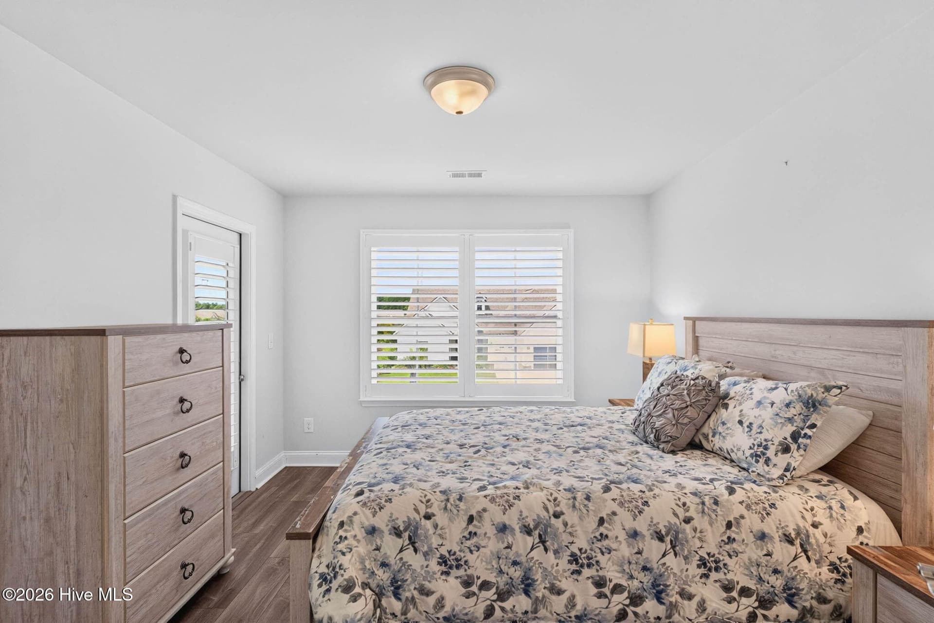 This inviting guest bedroom offers a comfortable layout with neutral finishes and a bright rear-facing window. - 139 Eagle Claw Drive, Calabash, NC 28467