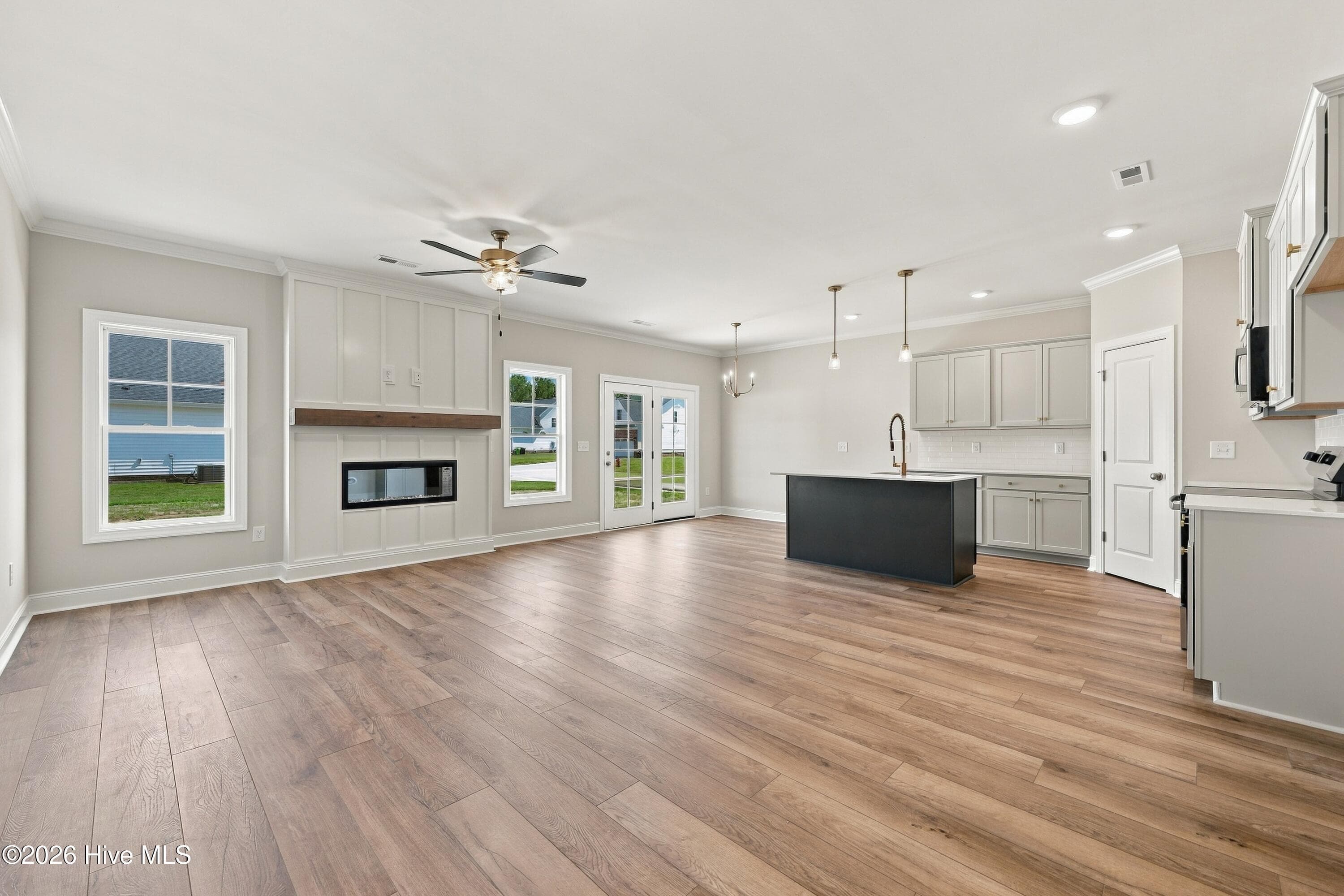 Living and kitchen open with eat in area and center island with room for stools - 3229 Meadow Drive, Farmville, NC 27828