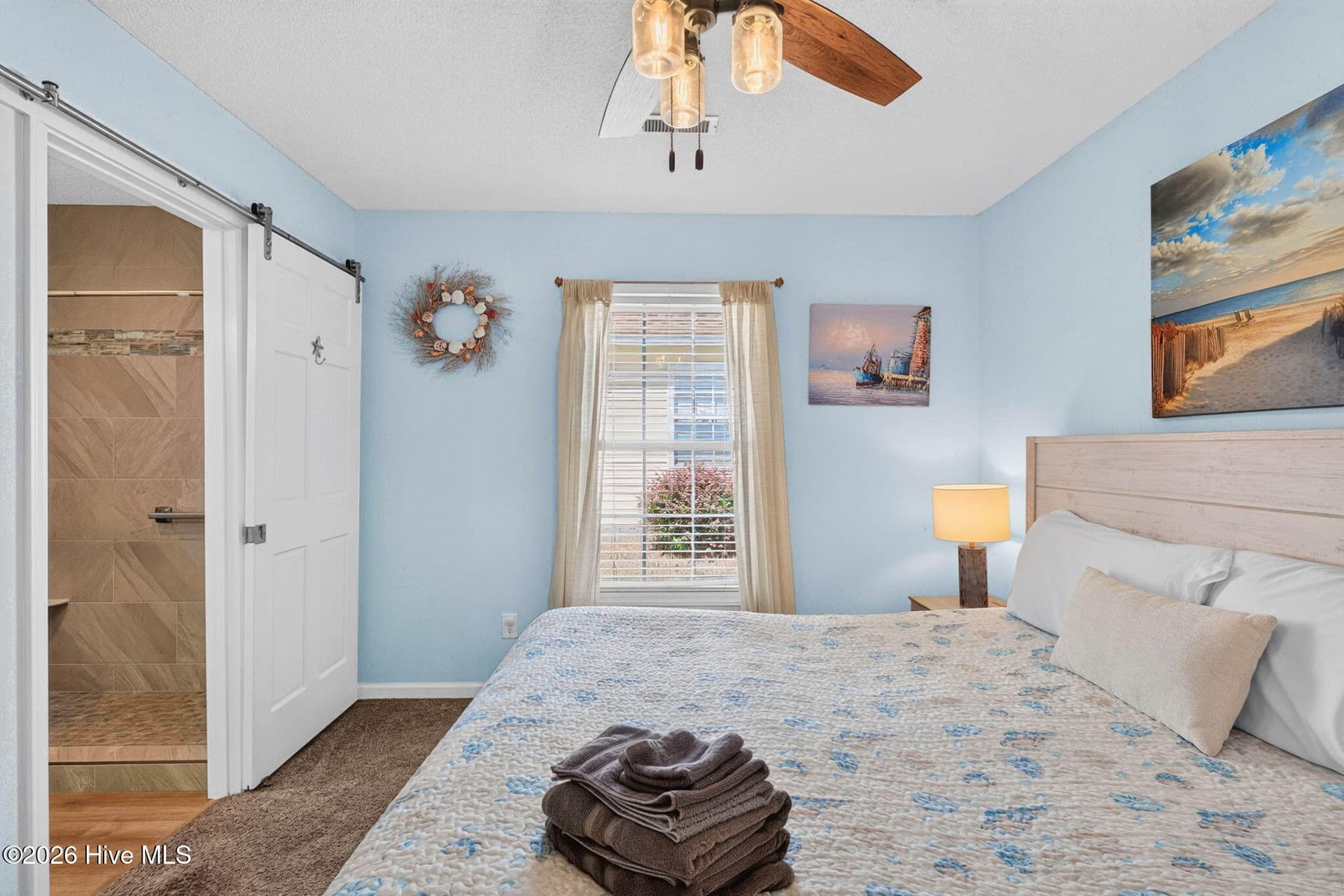 Primary suite offers a relaxing retreat with coastal-inspired finishes and an ensuite bathroom. - 1650 Frink Street SW, Ocean Isle Beach, NC 28469