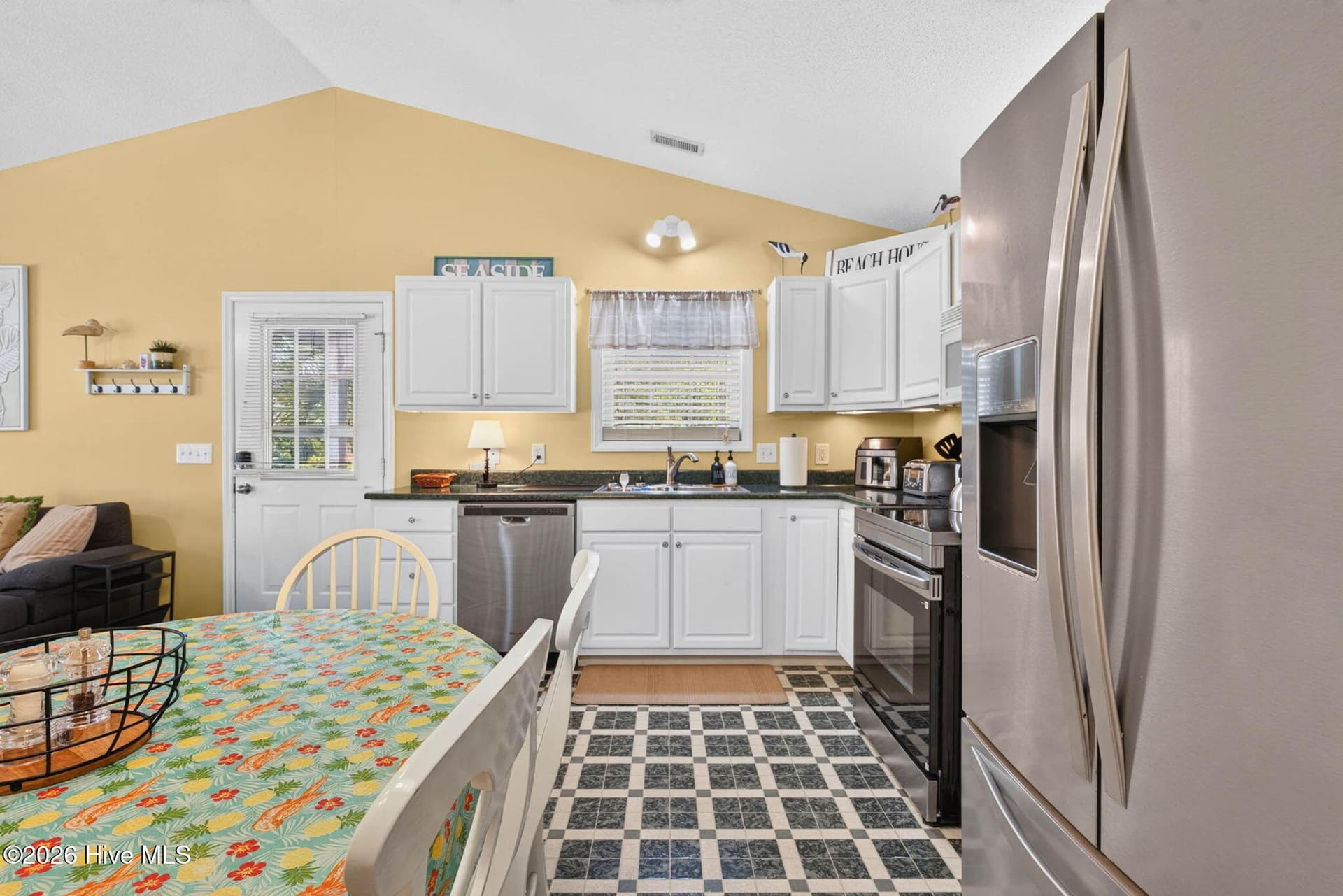 Functional kitchen layout with plentiful storage and easy access to the home's dining and living spaces. - 1650 Frink Street SW, Ocean Isle Beach, NC 28469