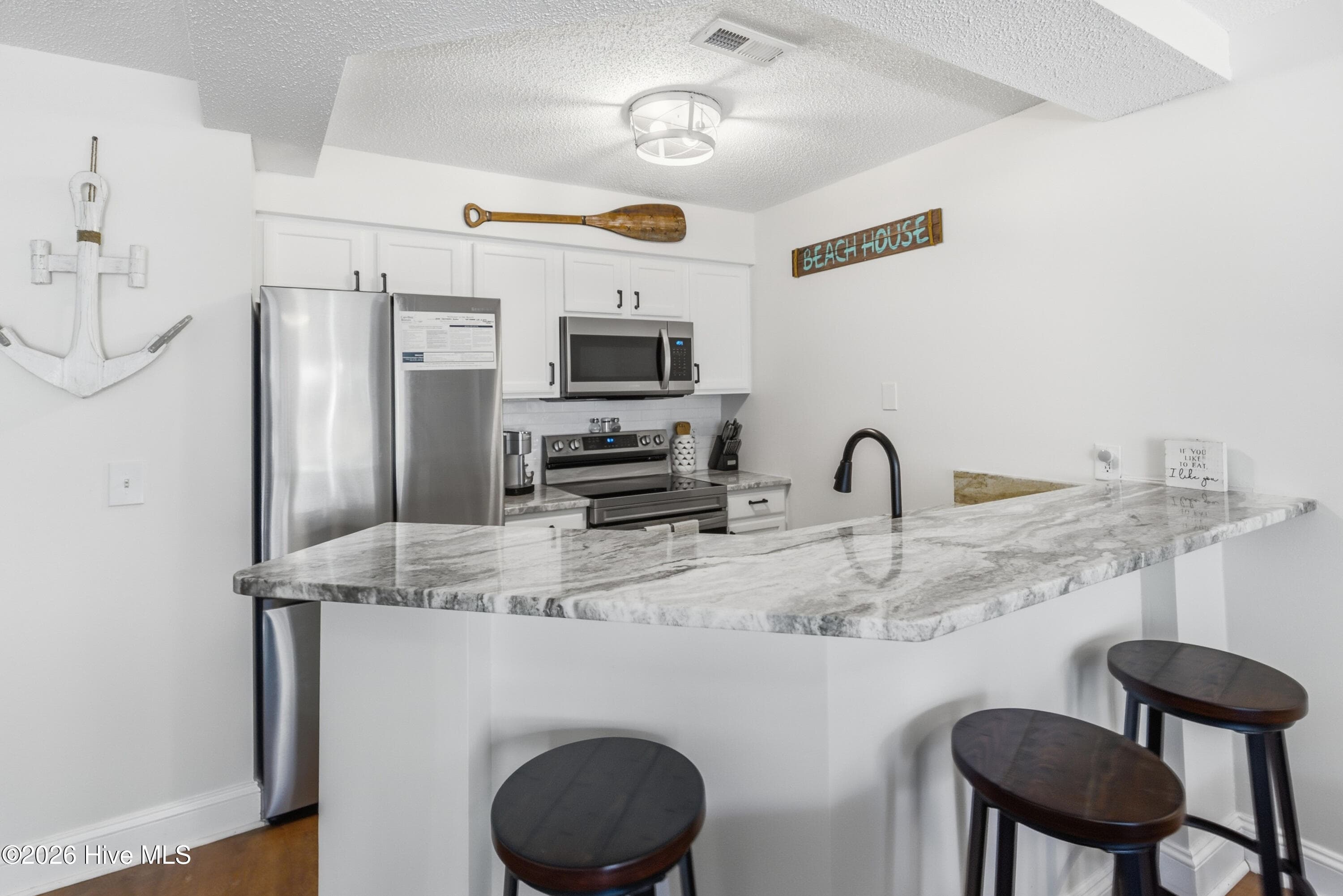 Fully furnished Kitchen/Dining with updated appliances and granite - 908 Resort Circle Unit 203, Sunset Beach, NC 28468