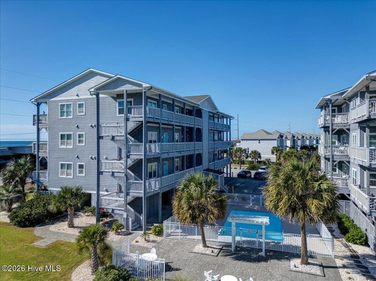 Community pool between the buildings with shower - 104 Pelican Drive H, Atlantic Beach, NC 28512
