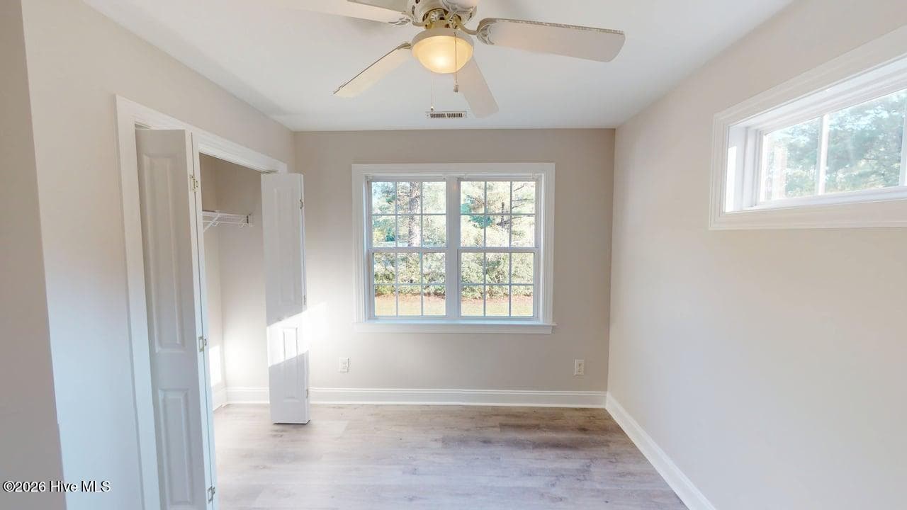 Bedroom 2 has plenty of natural light with the double window looking over the front yard, and the clerestory window! - 1114 Barkentine Drive, New Bern, NC 28560