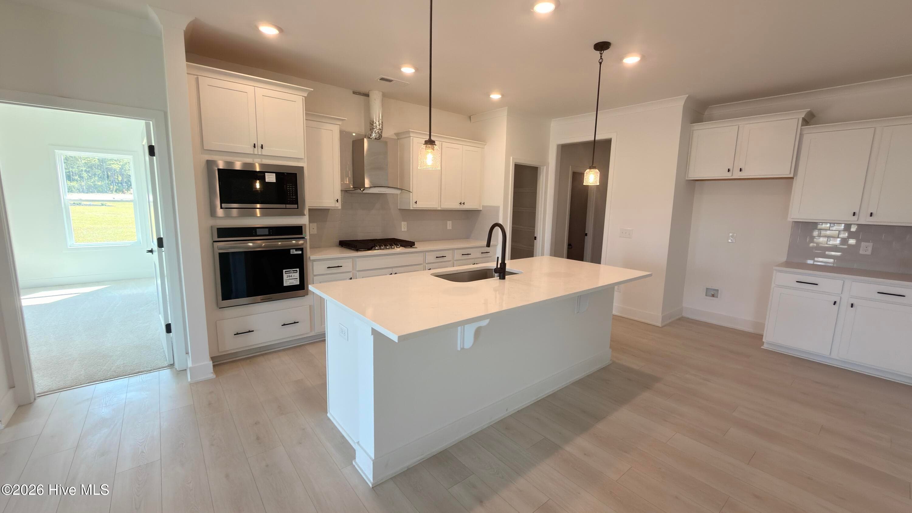 Kitchen with Primary bedroom to left - 2129 Sandbrook Loop, Leland, NC 28451