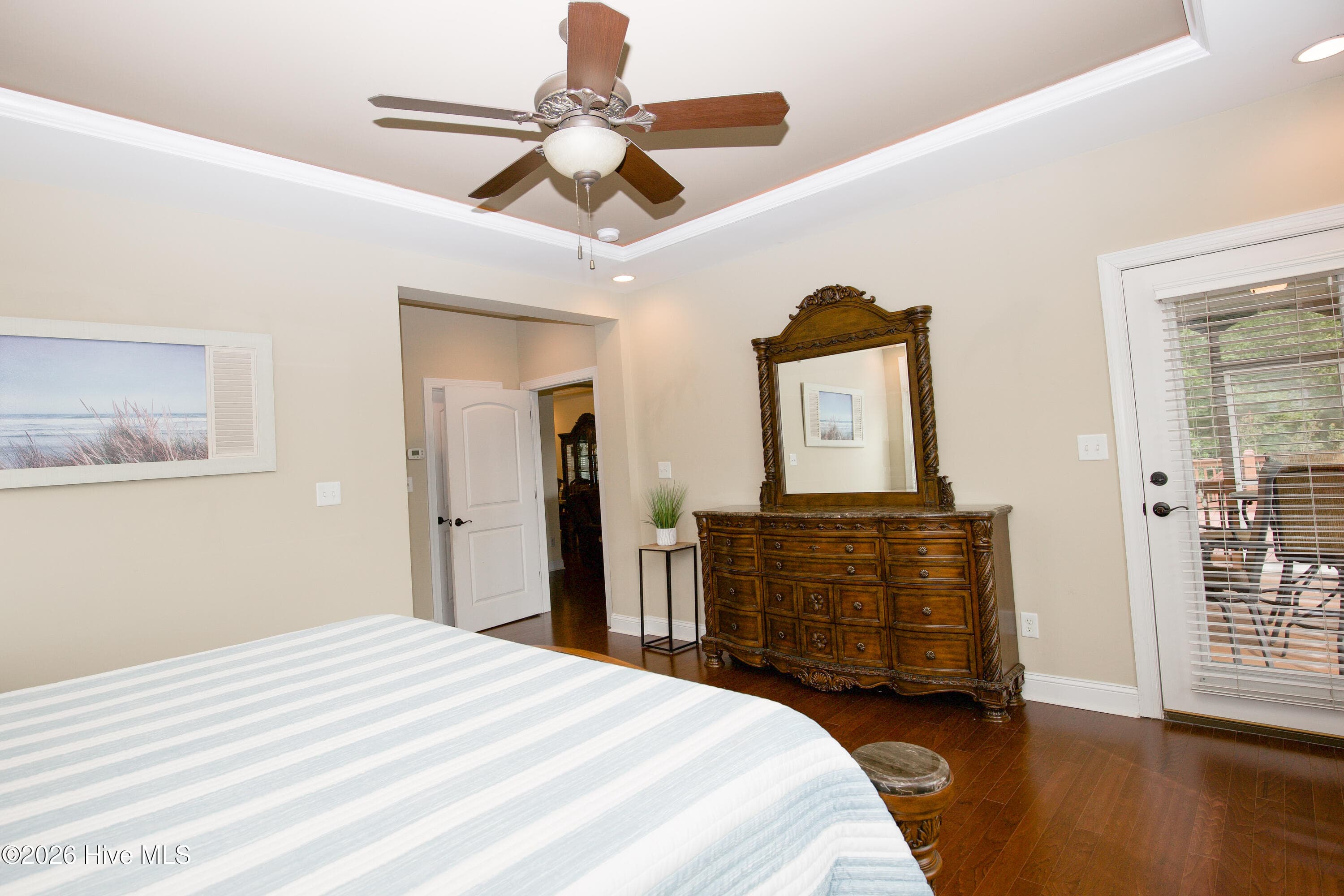 Primary bedroom looking toward the hall, with the porch door at right. - 899 Seagull Drive, Vass, NC 28394, Vass