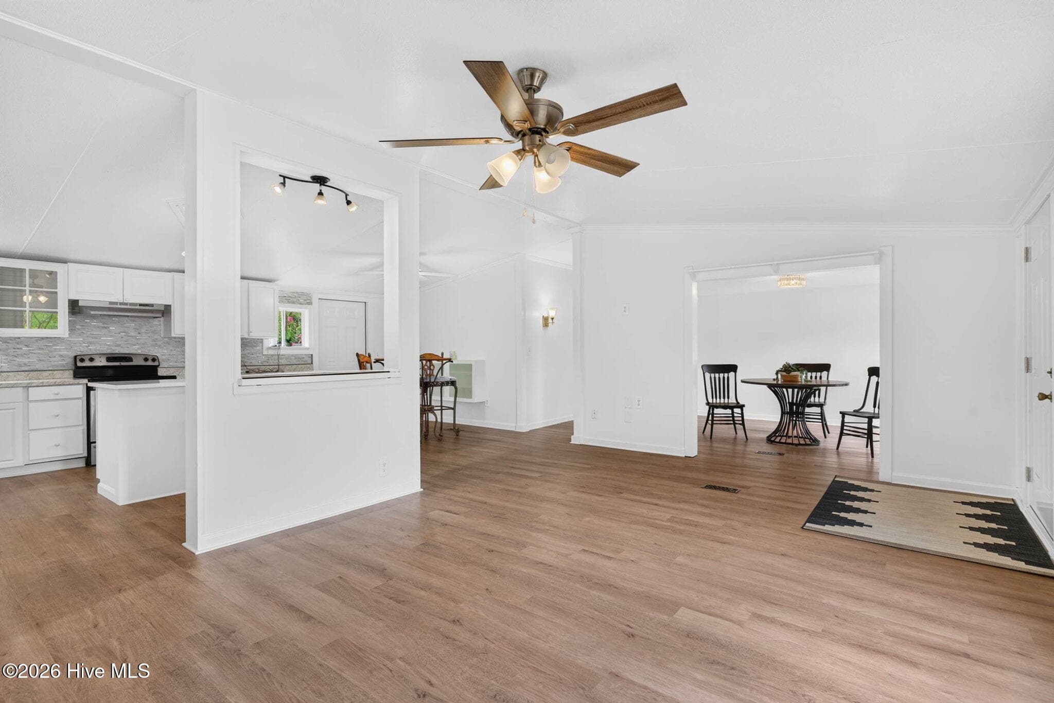Spacious main living area with modern finishes and an effortless flow into the beautifully renovated kitchen for easy entertaining. - 1199 Zack Street SE, Bolivia, NC 28422