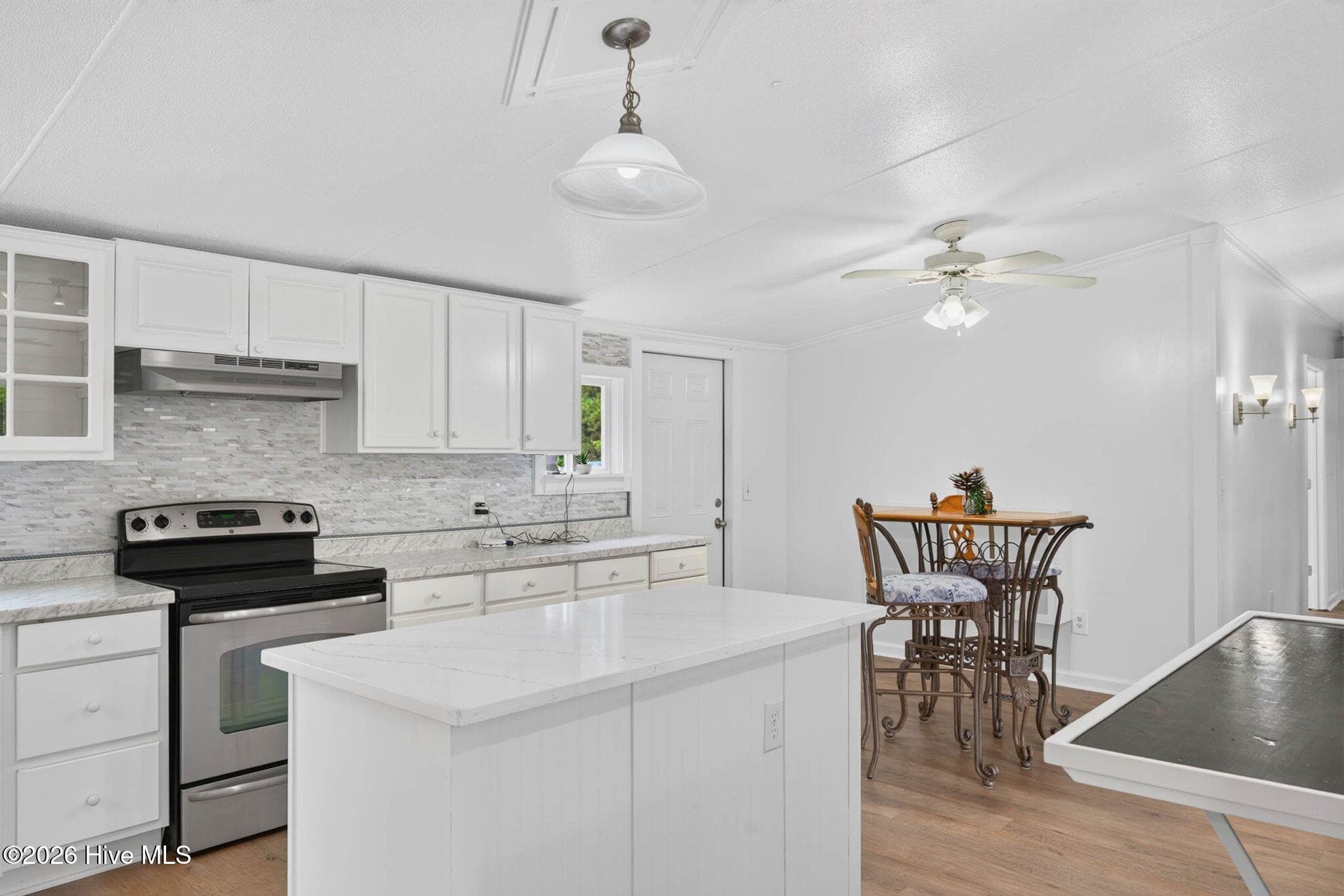 The beautifully renovated kitchen offers abundant cabinetry, generous prep space, and an open layout that keeps you connected to the adjoining dining and living areas. - 1199 Zack Street SE, Bolivia, NC 28422