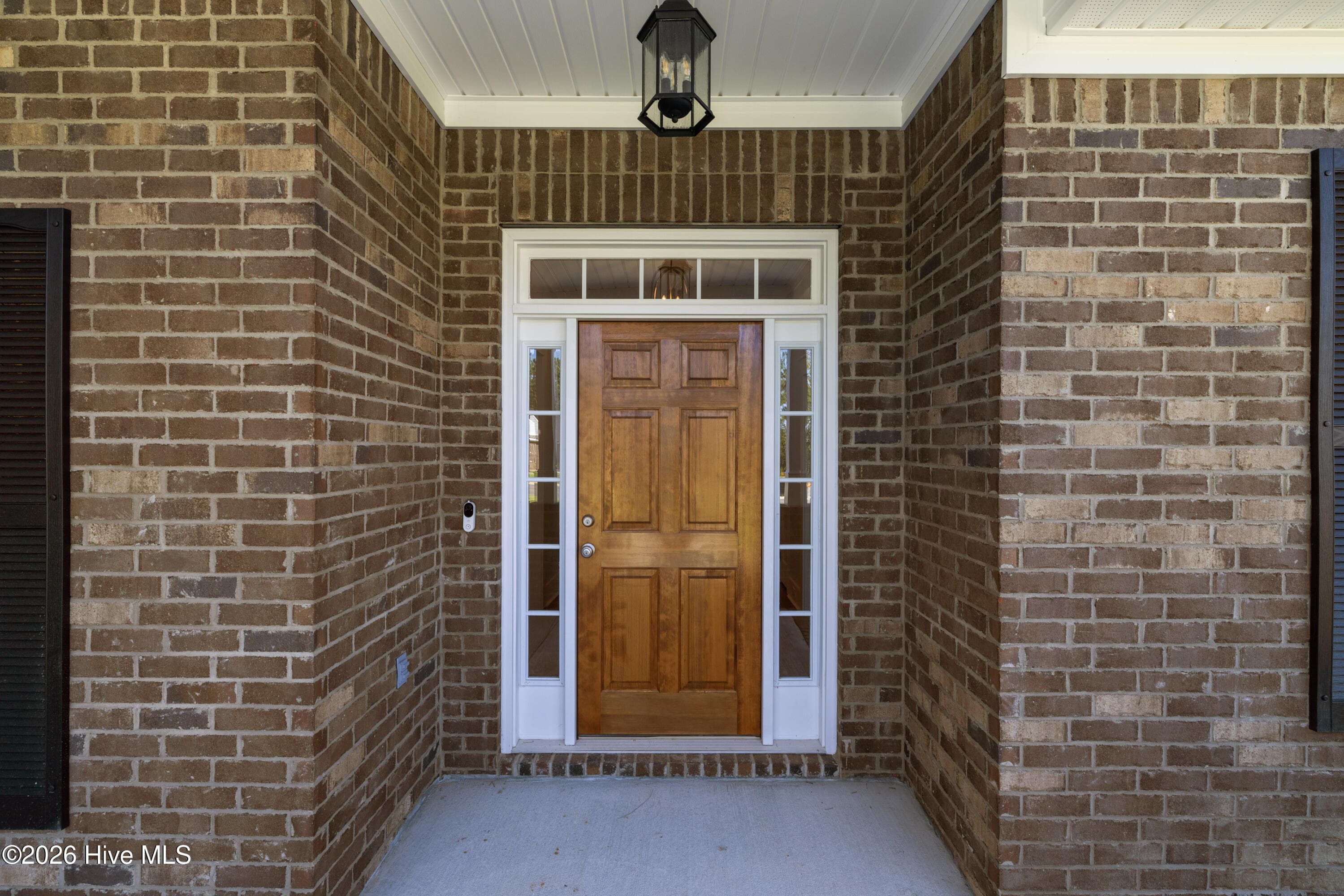 Inviting covered entry with elegant wood front door - 458 Longshadow Drive, Aiken, SC 29803