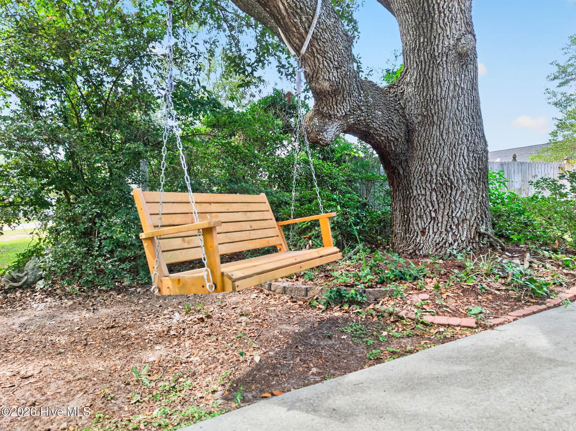 Mature shade tree and additional outdoor seating area create a peaceful spot to enjoy the Ocean Isle Beach lifestyle. - 1650 Frink Street SW, Ocean Isle Beach, NC 28469
