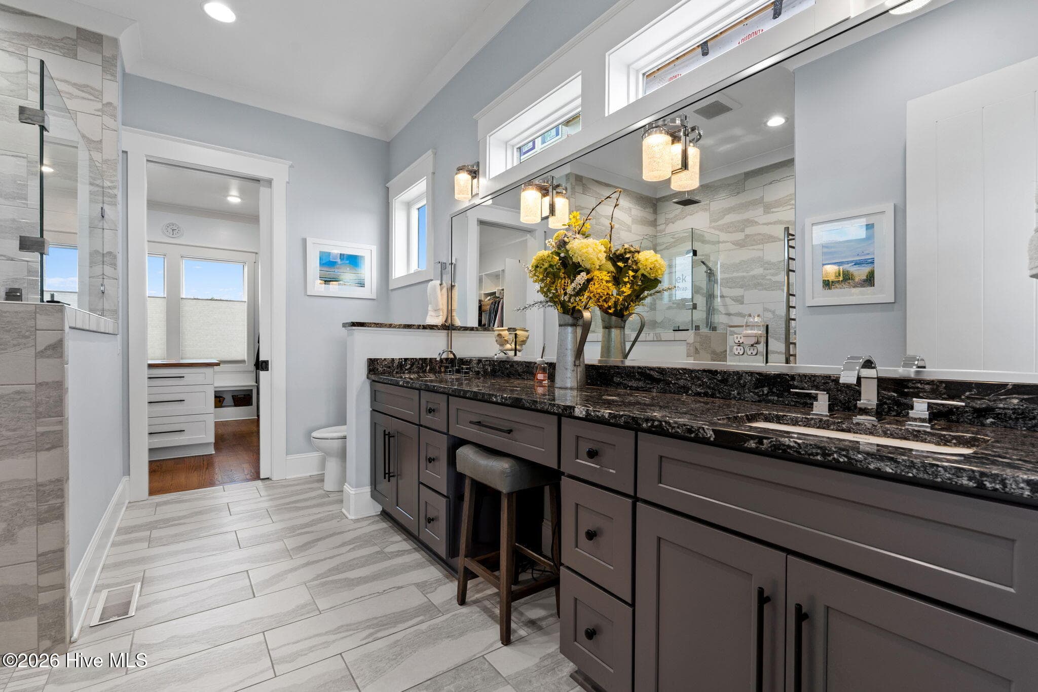 Double sinks with granite countertops, chrome fixtures, and radiant floor heating - 2775 Long Bay Drive SE, Southport, NC 28461