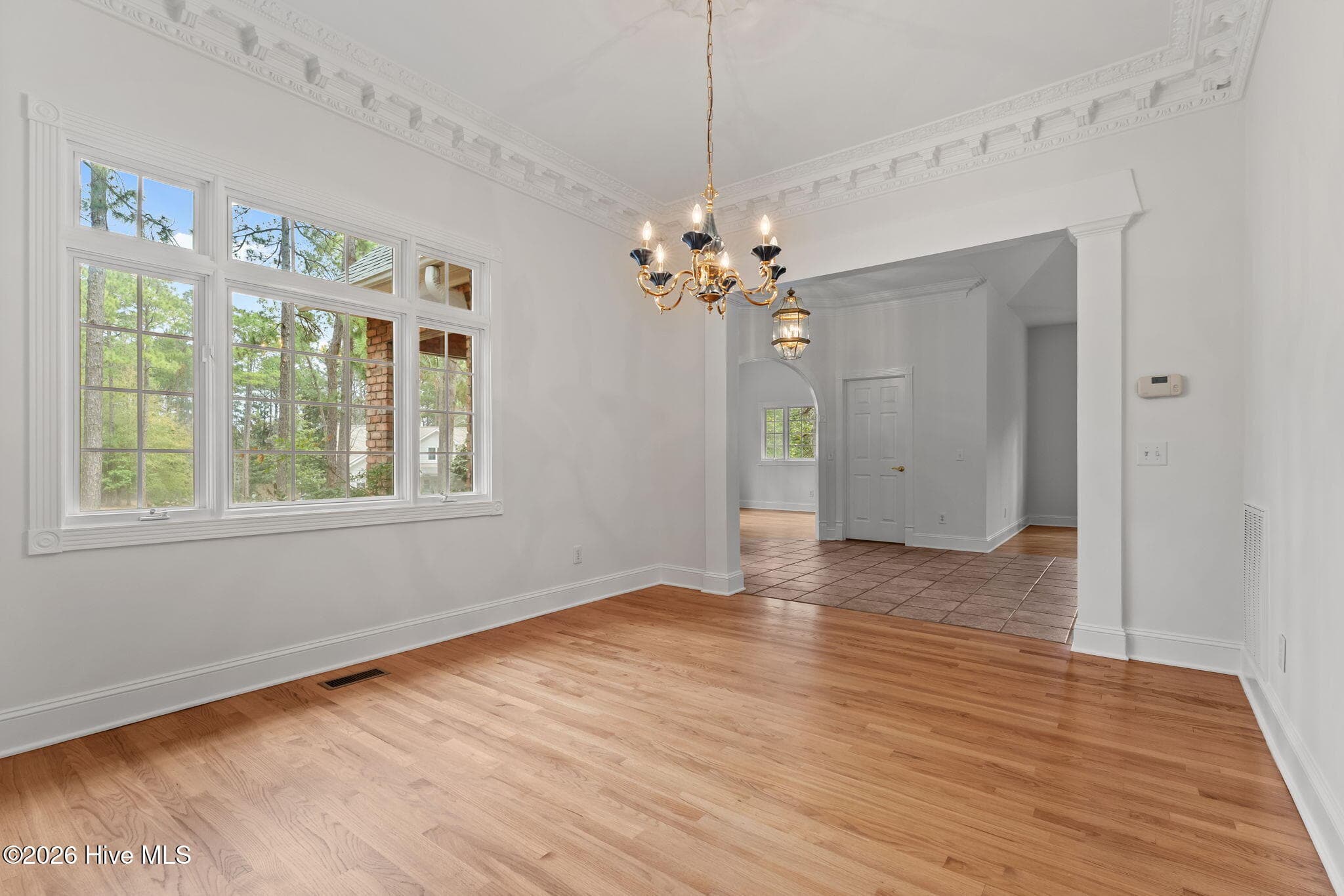 Dining room with gorgeous detailed dental molding that adds a nice atmosphere to the setting. - 22 Lochmere Drive, Pinehurst, NC 28374