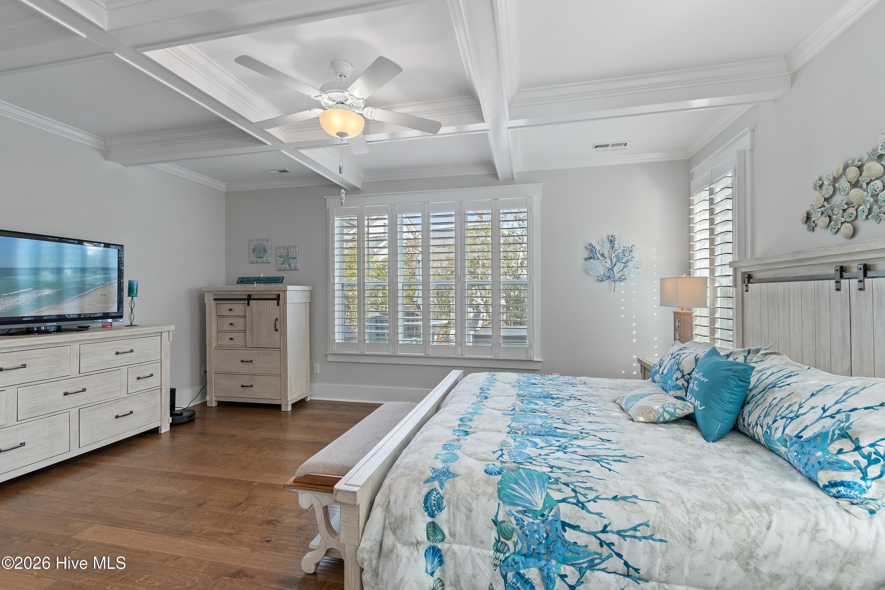Primary bedroom with plantation shutters. - 6358 Bryson Drive SW, Ocean Isle Beach, NC 28469