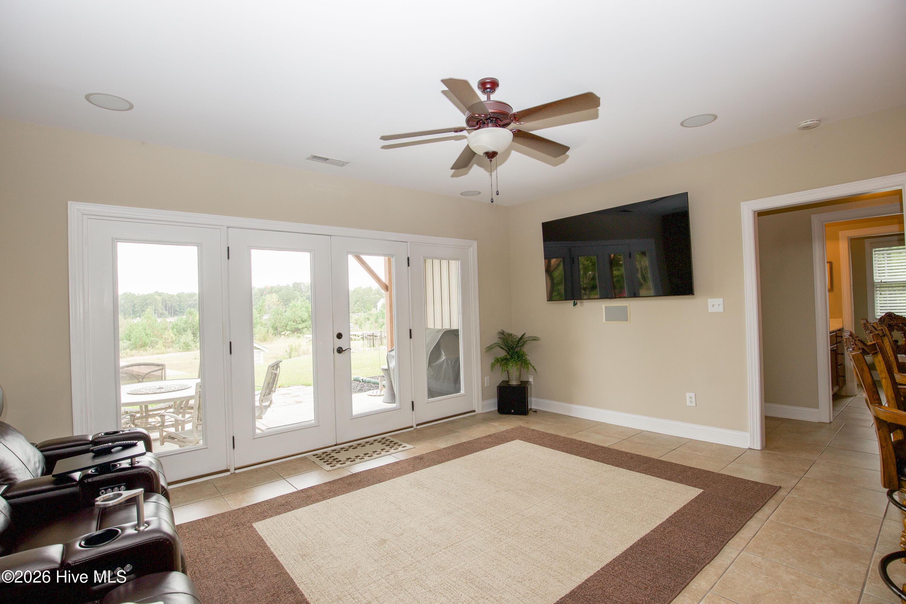 Lower-level media area with French doors to the covered patio. - 899 Seagull Drive, Vass, NC 28394, Vass